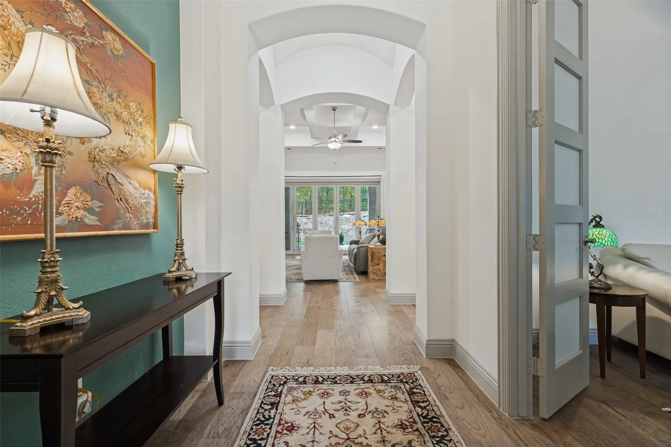 Gorgeous view from entrance showing the architectural details and leading to view of expansive windows overlookng backyard greenspace
