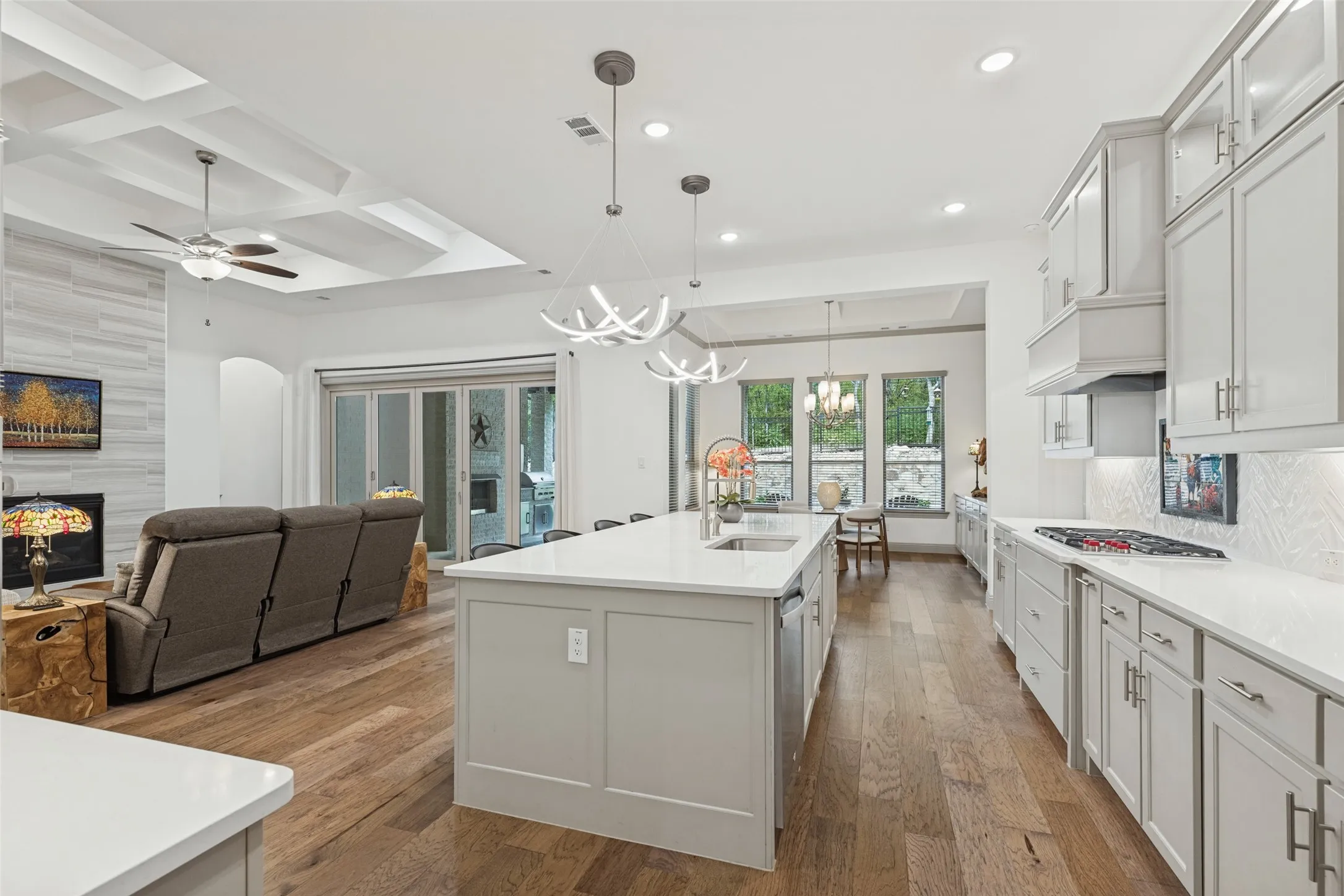 This home is perfect for entertaining or gatherings with family and friends. The chef's kitchen has quartz counters with lighted upper cabinets and an abundance of light throughout with relaxing views to the backyard