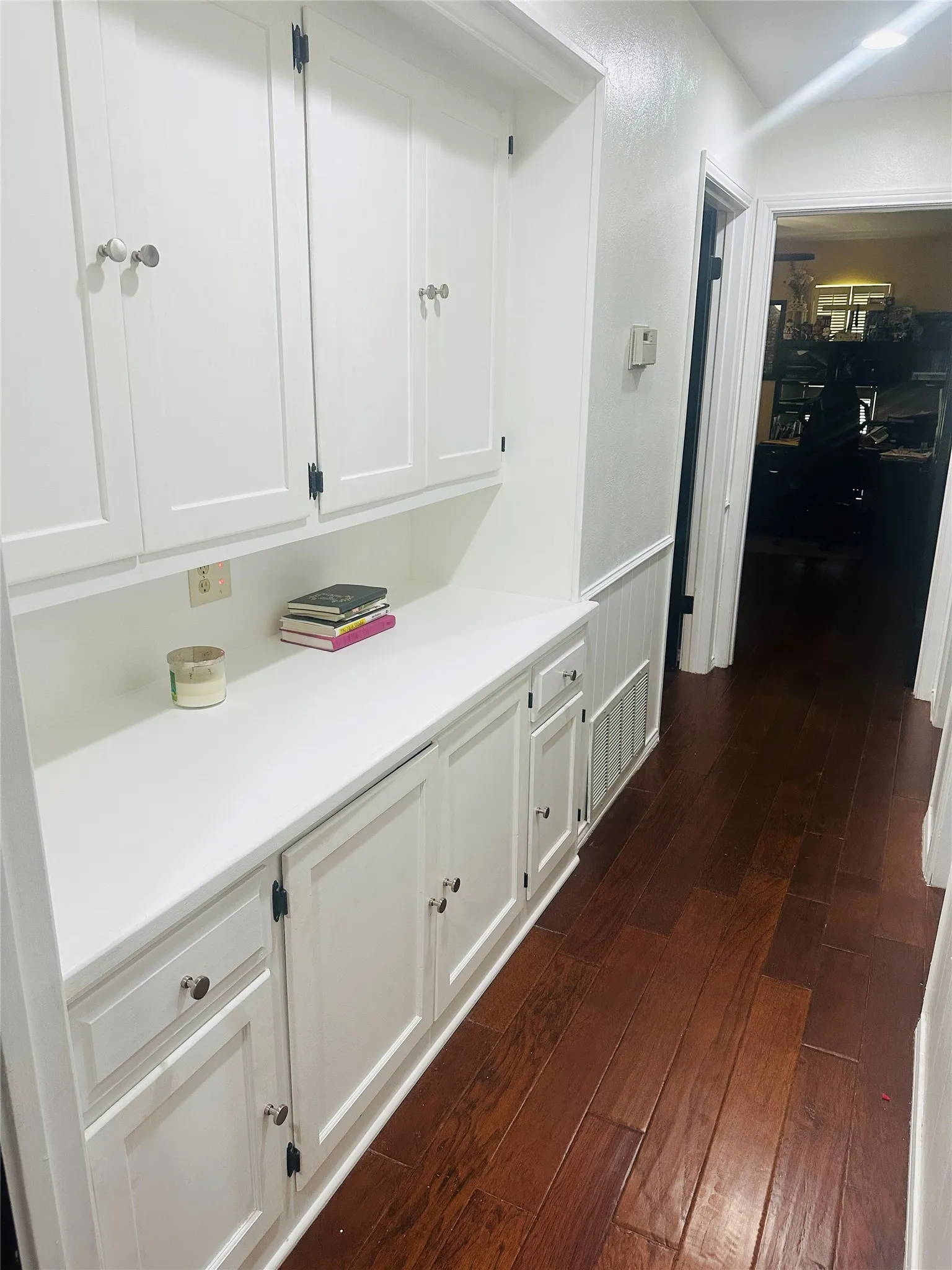 Built-in cabinetry with white shaker-style doors, upper and lower storage