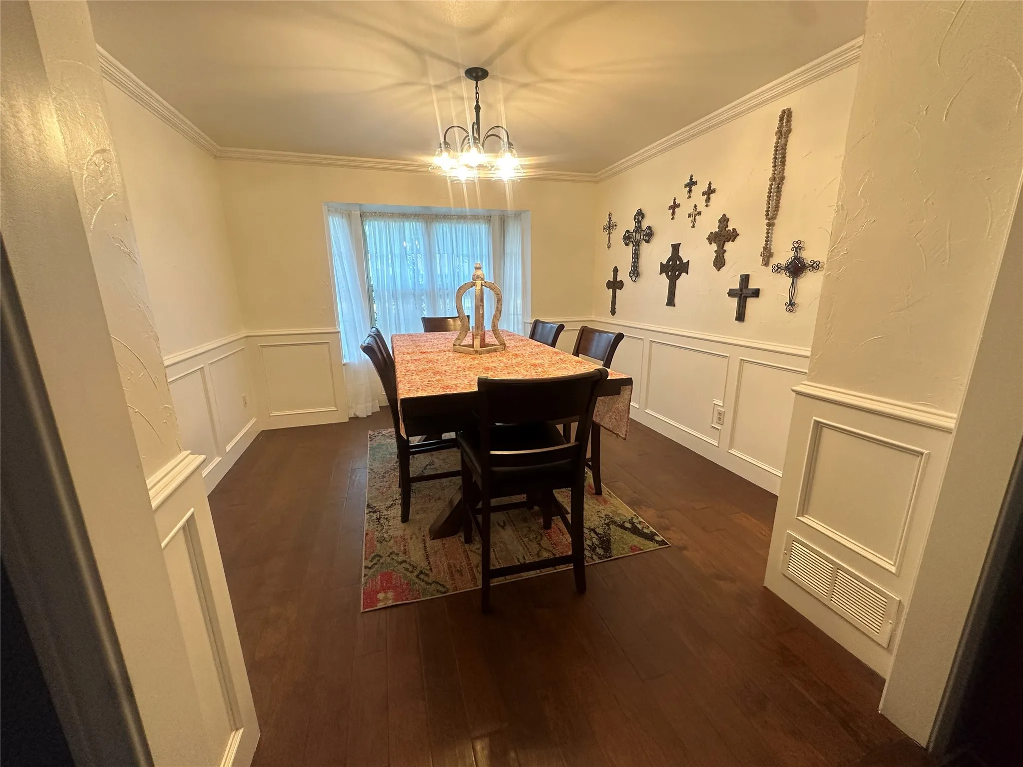 Hardwood-style flooring complemented by wainscoting and crown molding