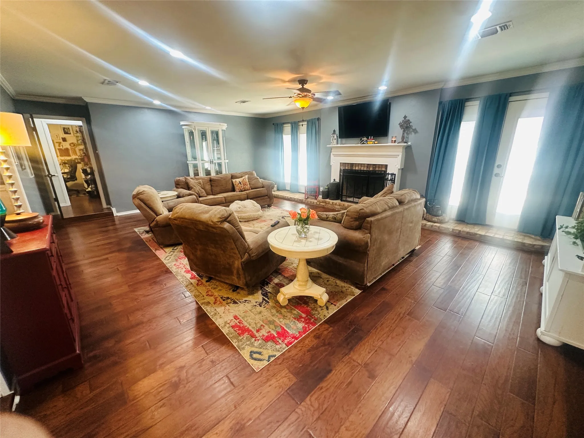 Wood-finish flooring, recessed lighting, and a ceiling fan