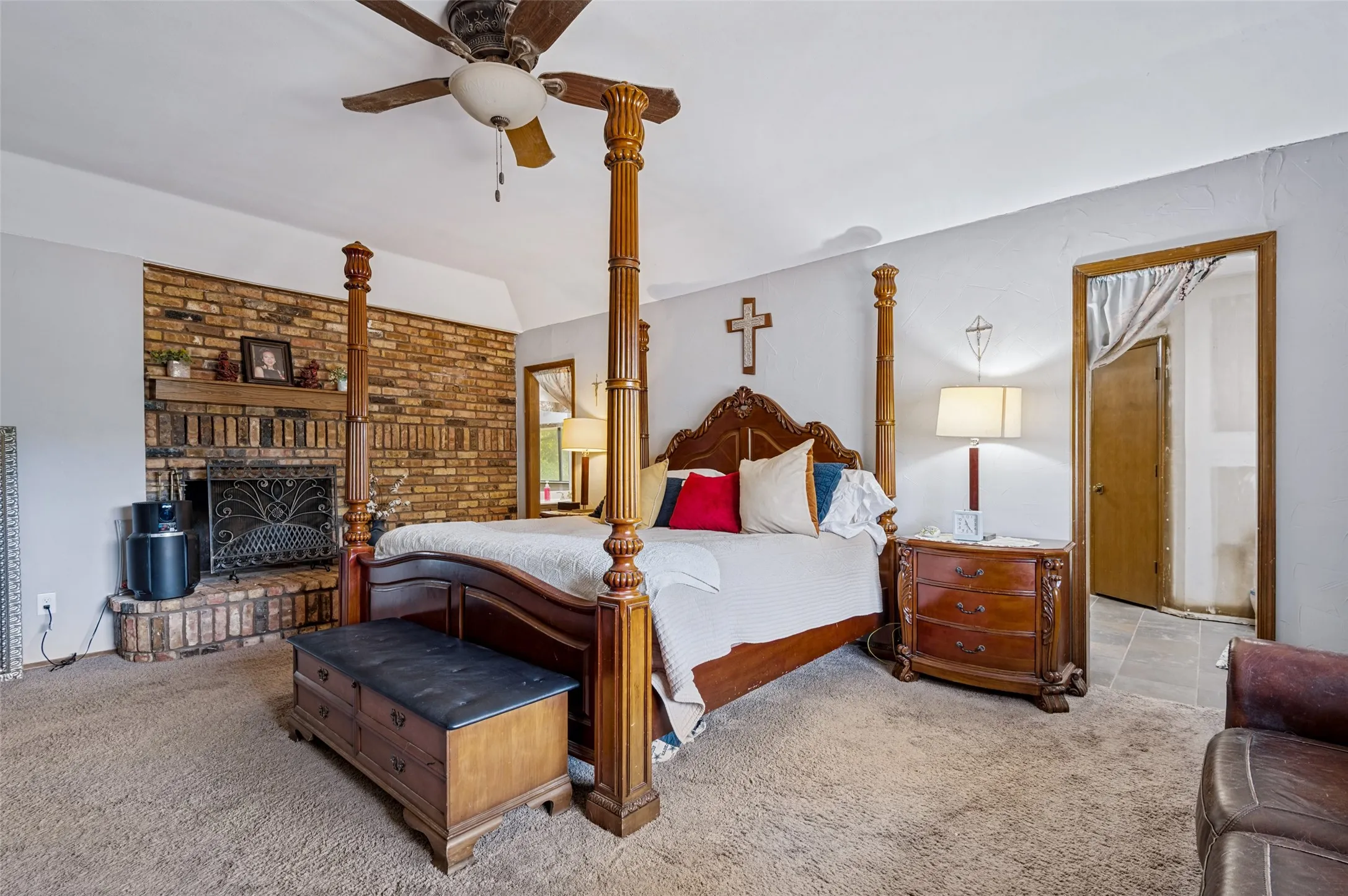 Another view of the generous primary suite, highlighting the fireplace, sitting space and connection to the primary bath.