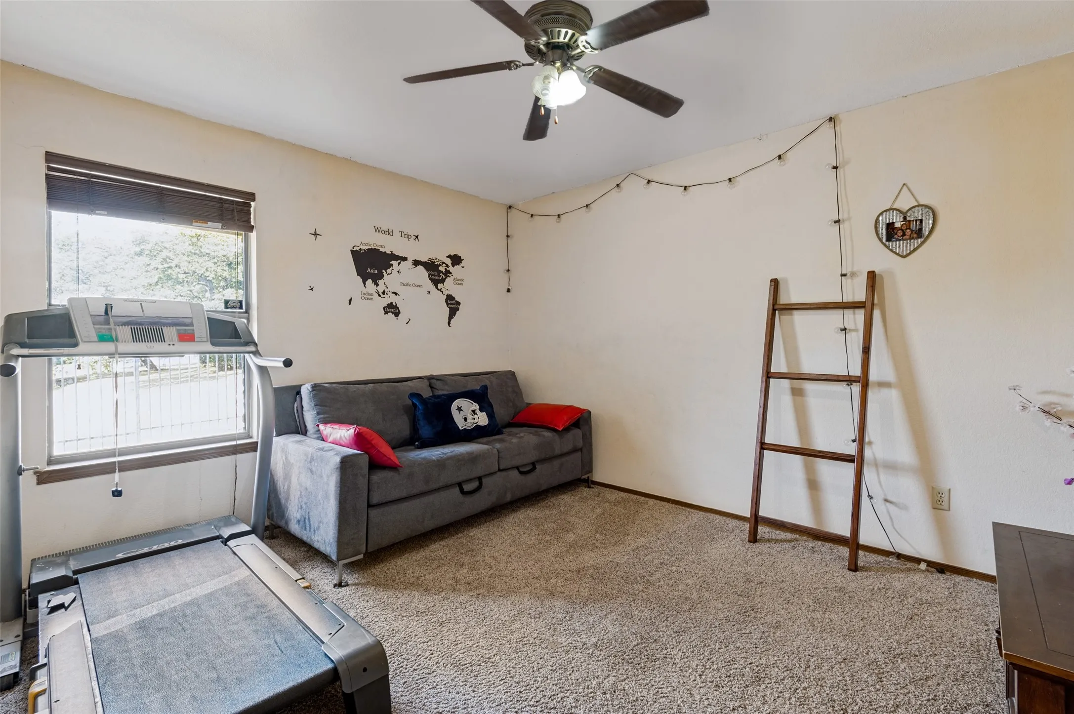 Secondary bedroom located near the primary suite with natural light and flexible space for guests, family or a home office.