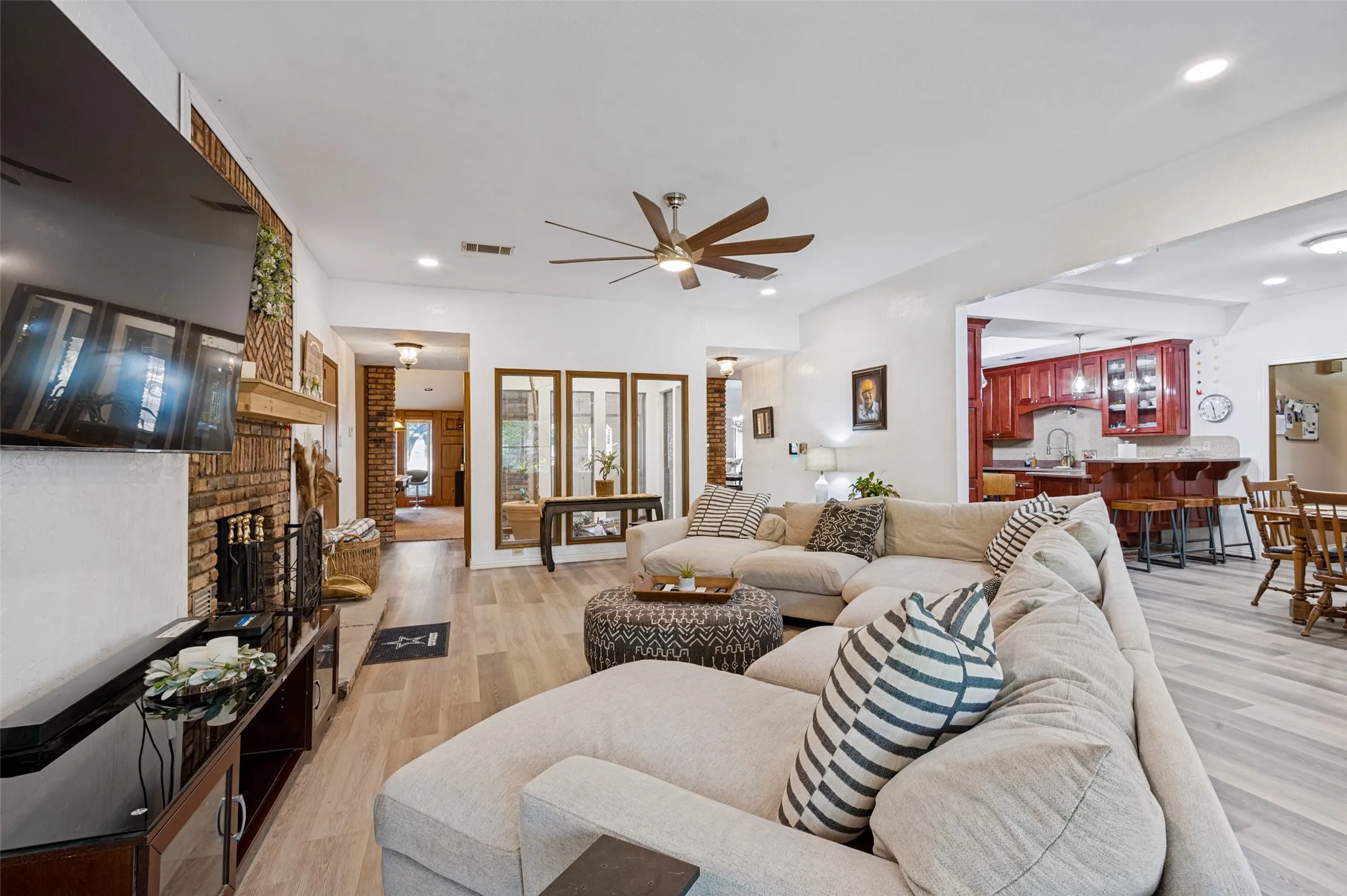 Expansive great room offering open sightlines to the entry and interior atrium, highlighting the home's distinctive architecture and flowing single-story layout.
