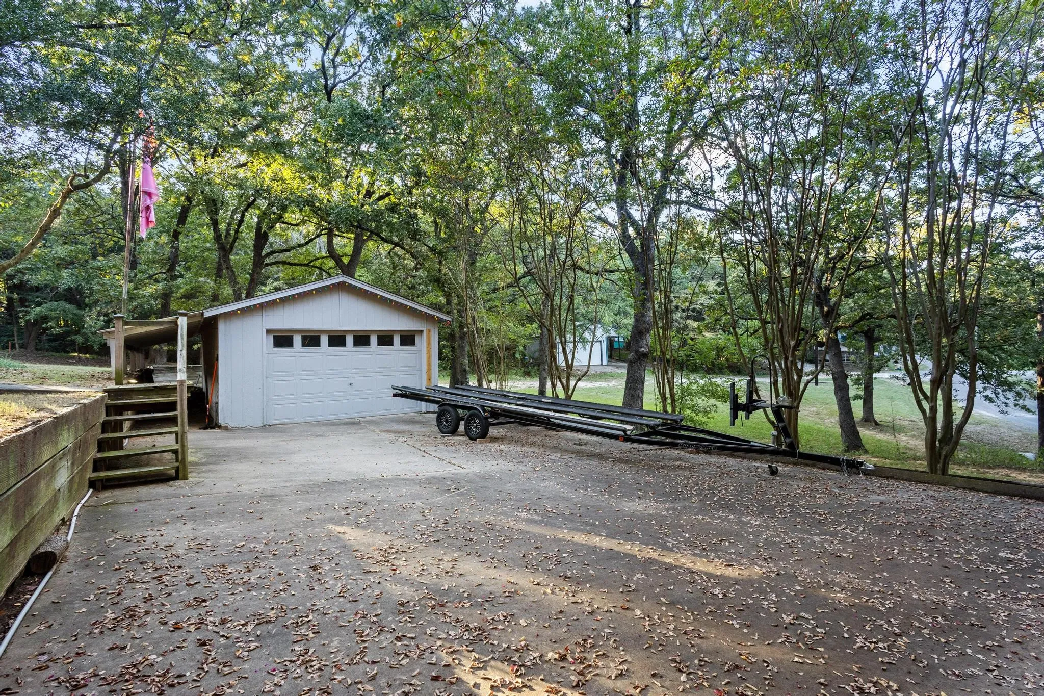 The Detached Garage with Electricity and Covered Extension is Ideal for Vehicle/Boat/Lake Toy Storage or a Workshop