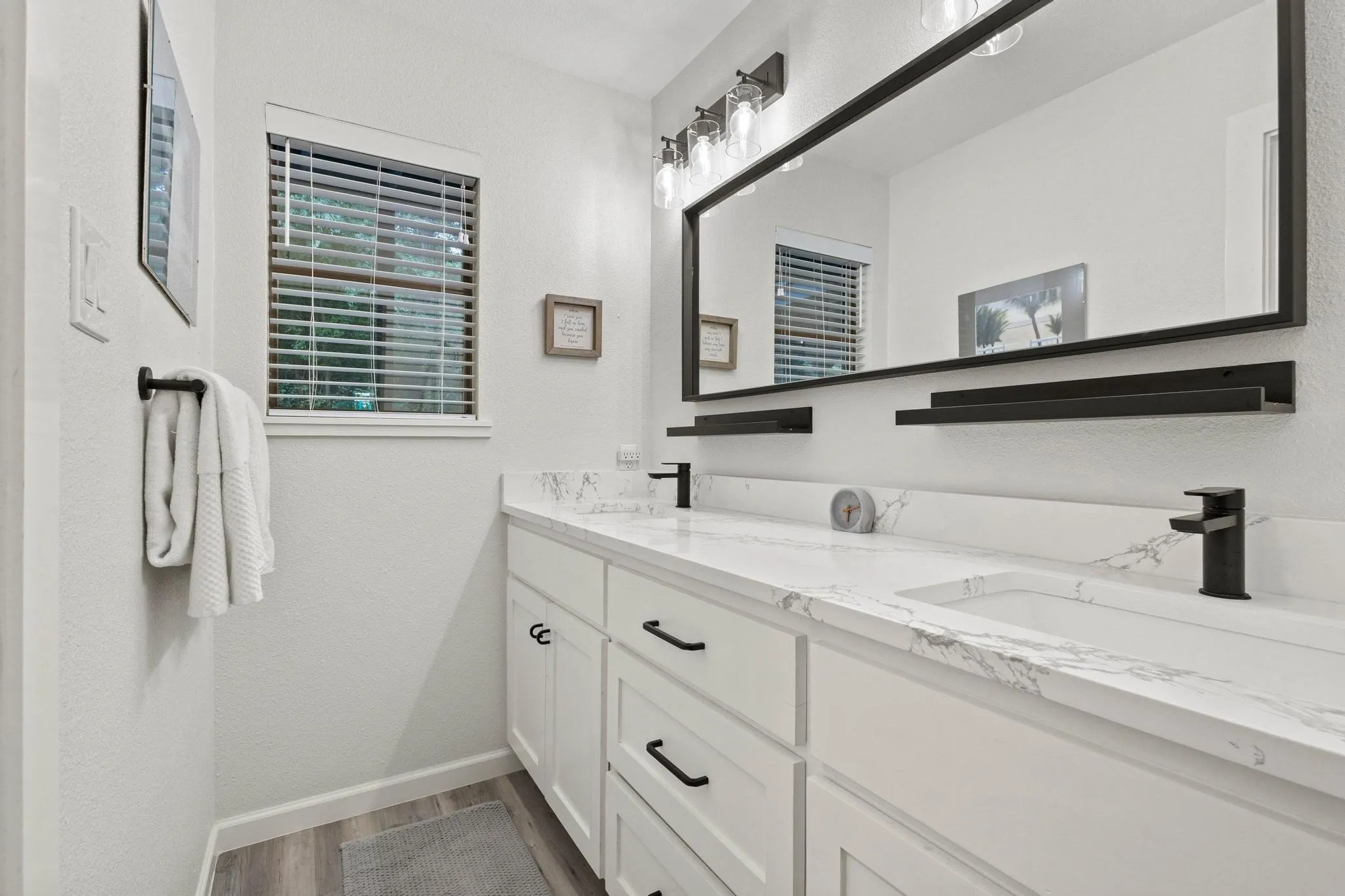 Dual Sinks, Modern Lighting and Quartz Top Elevate the Primary Ensuite Bath