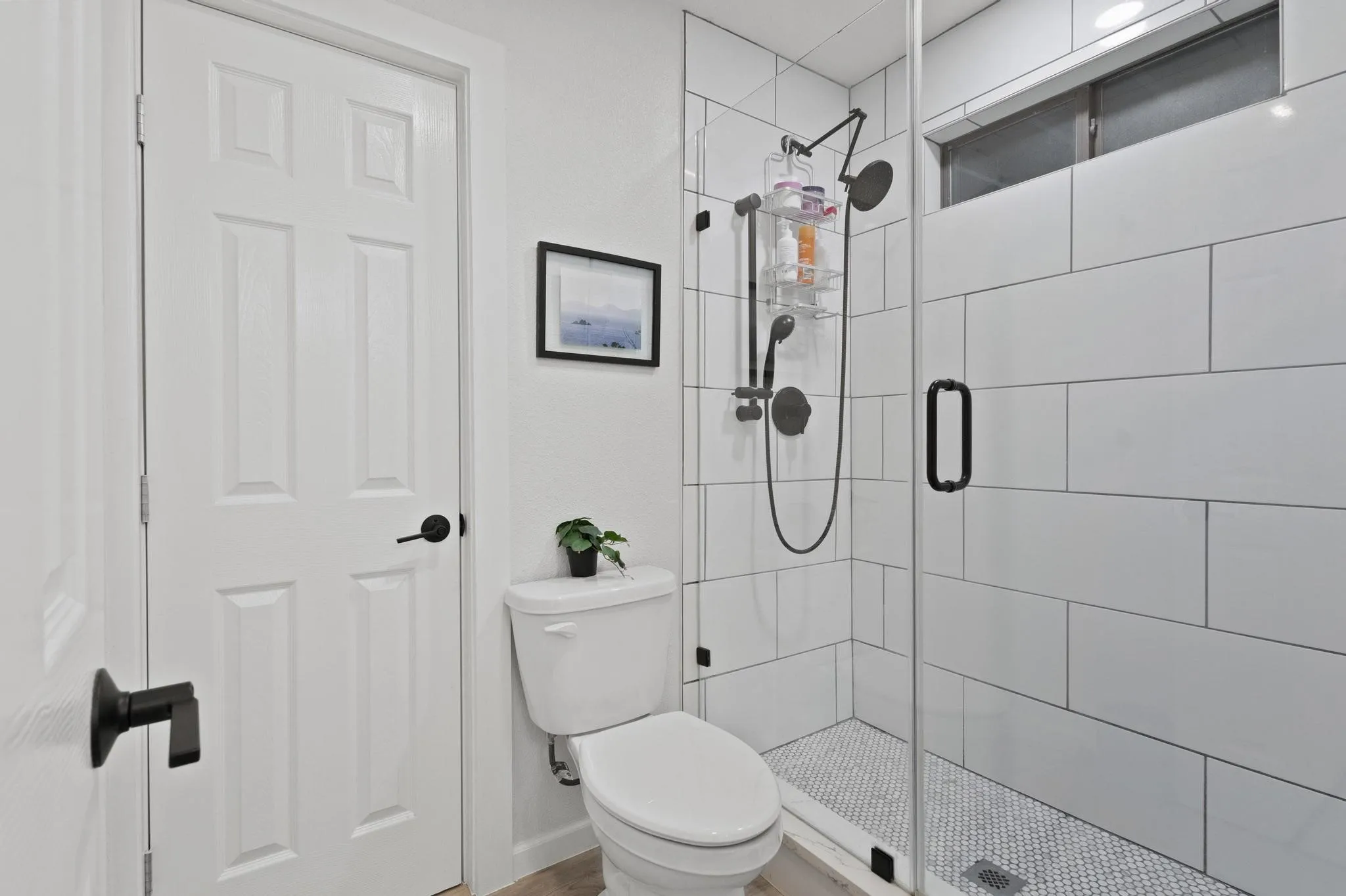 Large Format Tile to the Ceiling and Oversized Glass Doors in the Primary Bathrom