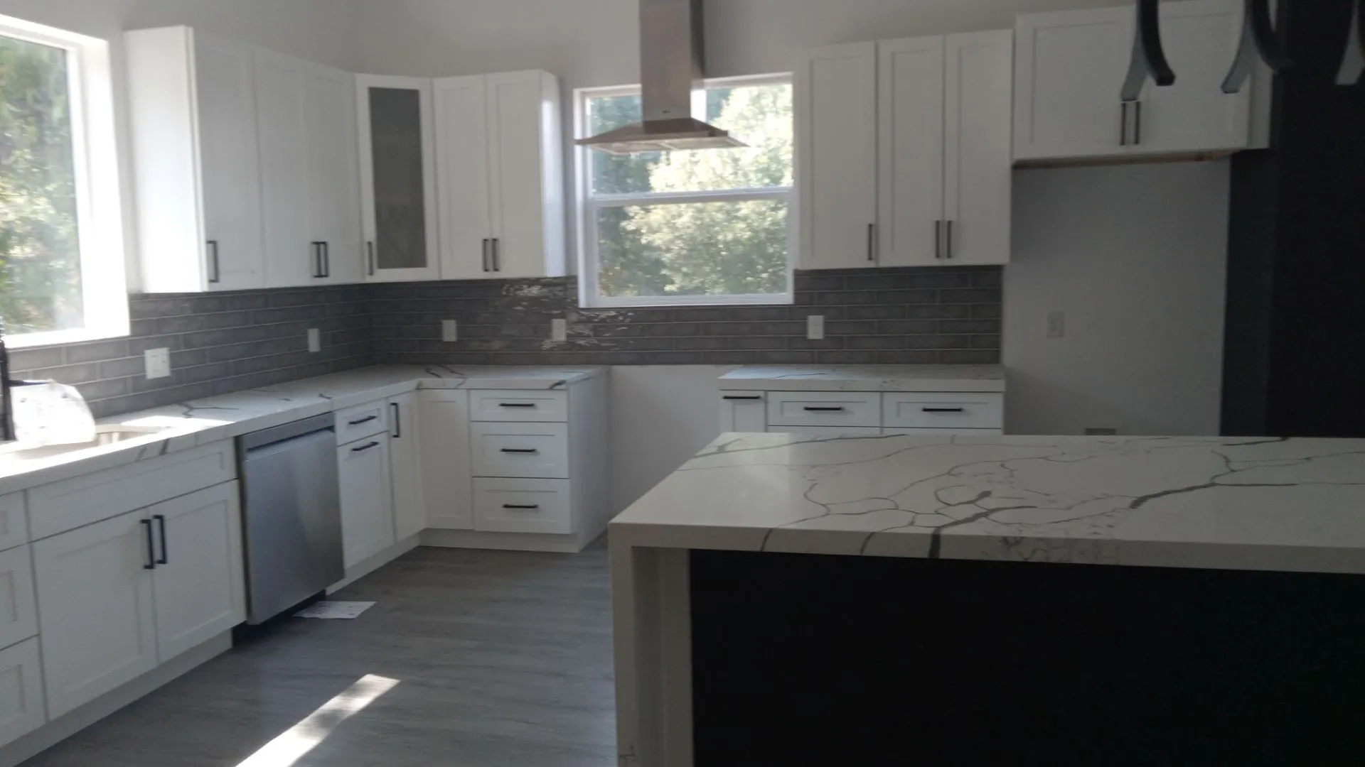 White shaker cabinetry complemented by a dark subway tile backsplash