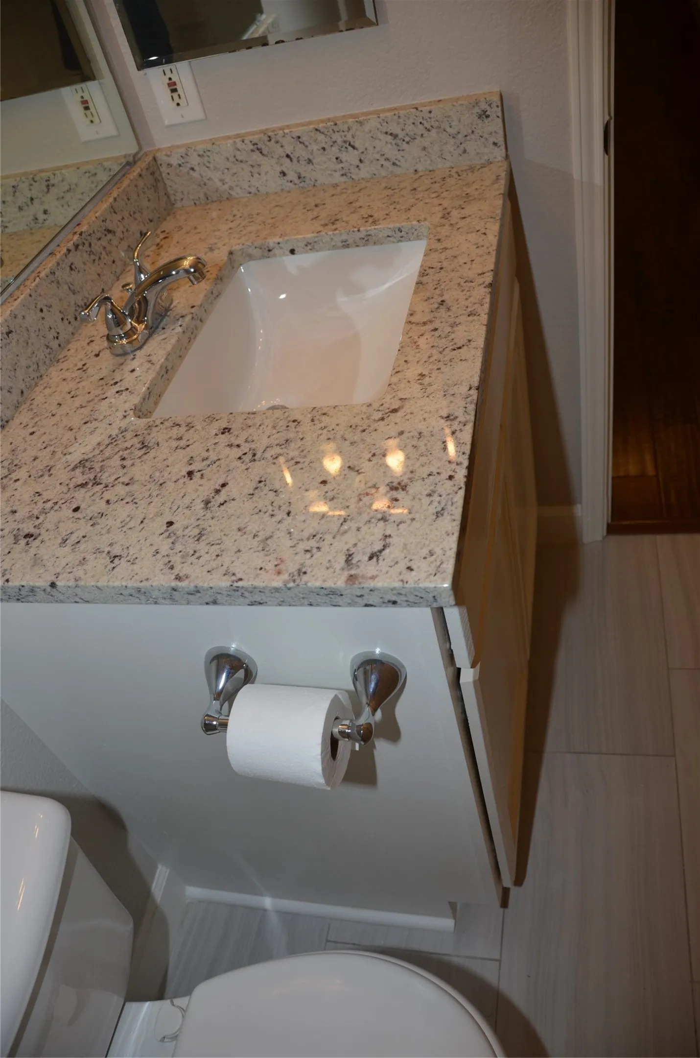 Vanity with stone-finish countertop, integrated rectangular sink, and chrome faucet