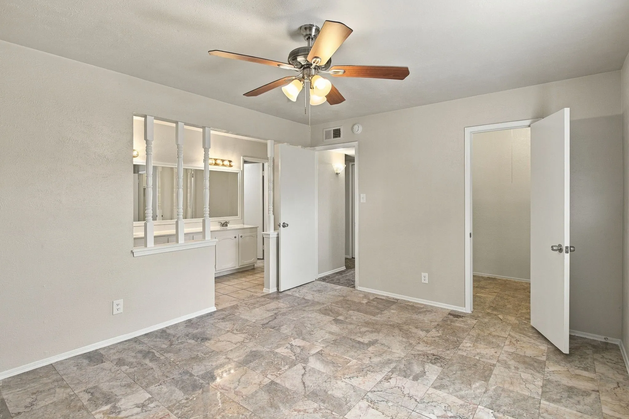 Neutral-toned walls complement the patterned tile flooring