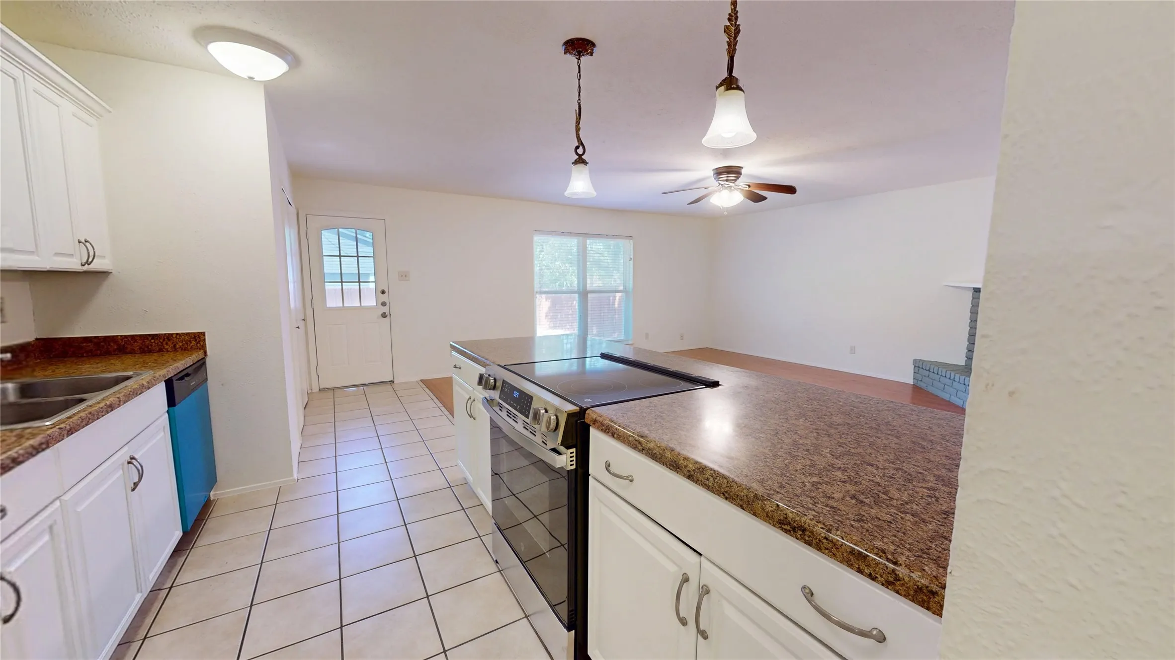 Kitchen featuring white cabinetry, tile flooring, and a built-in electric range