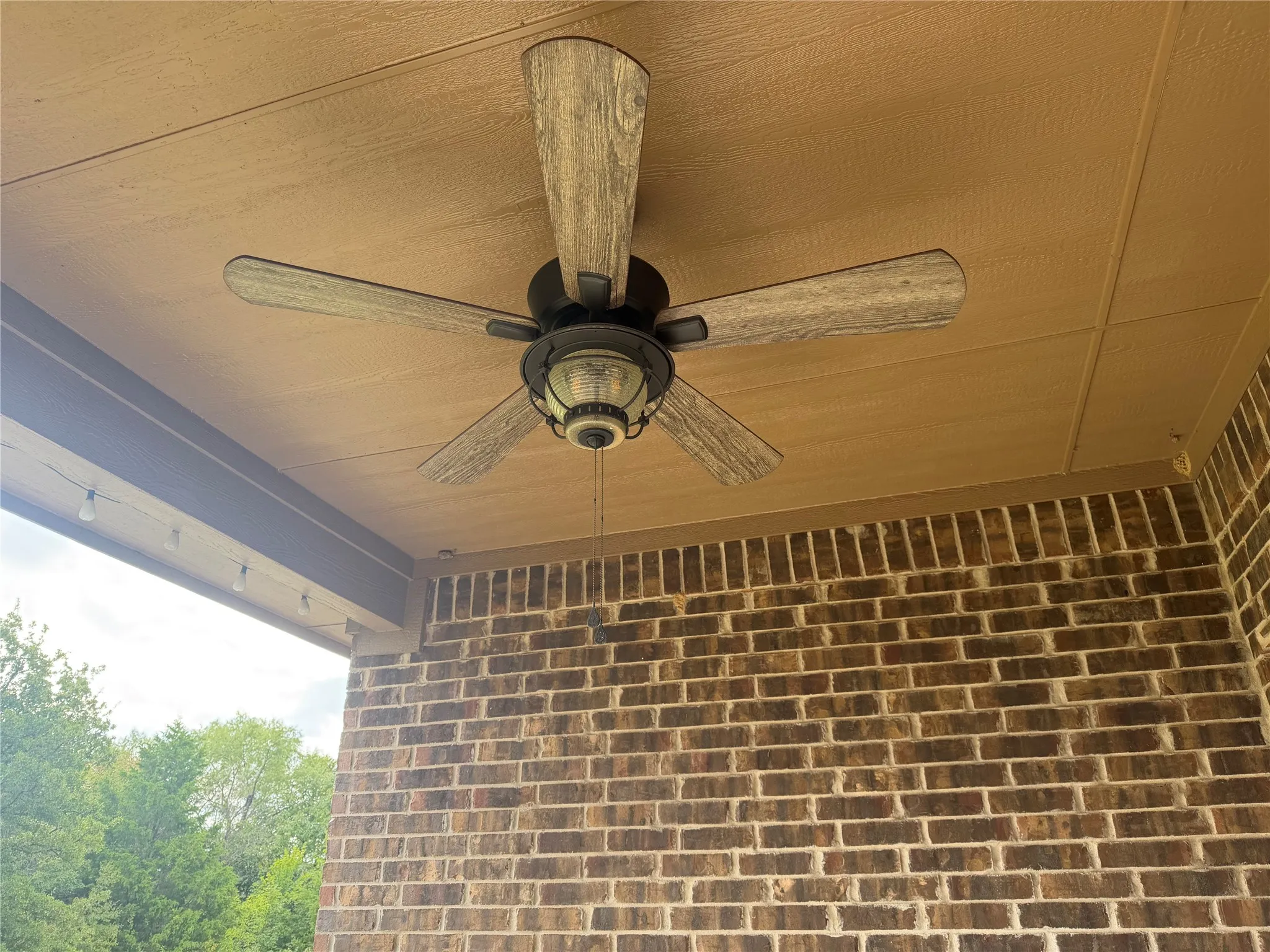 Back patio with ceiling fan.