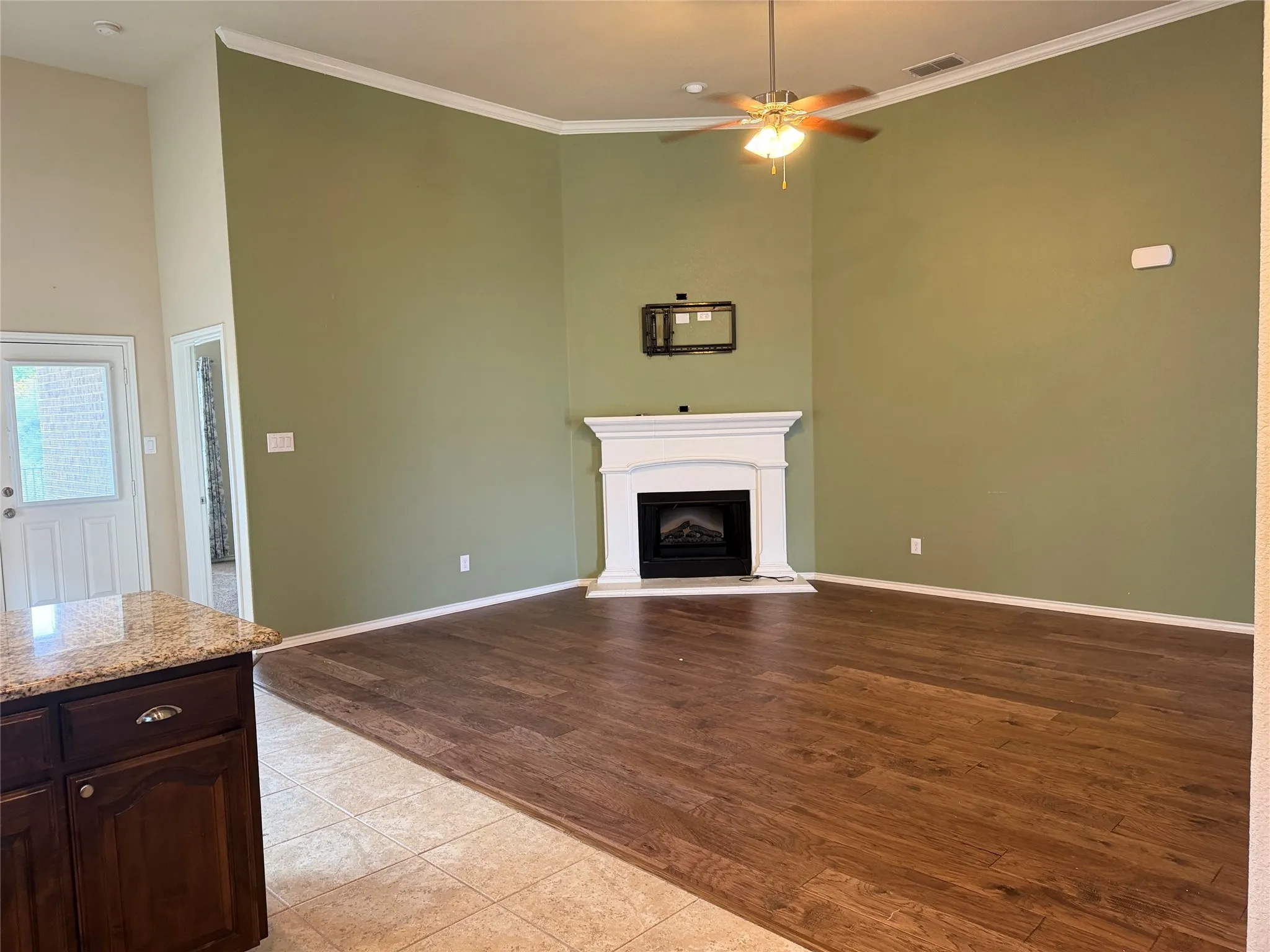Upgraded with crown molding and cast woodburning fireplace. TV  brackets left behind for ease of your installation and wiring has been completed as well.