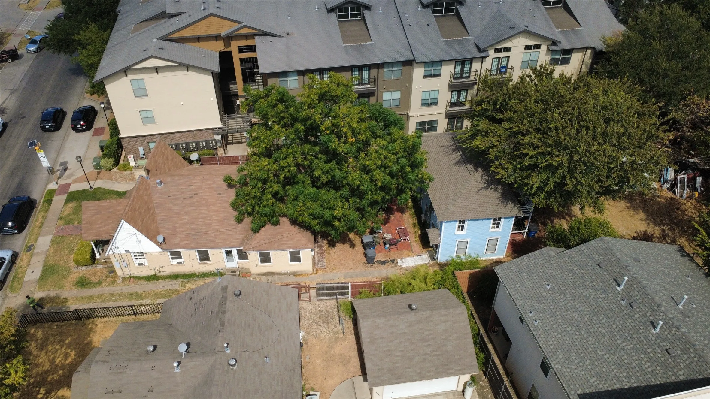 High-angle aerial looking toward adjacent multi-family developments and neighborhood context.