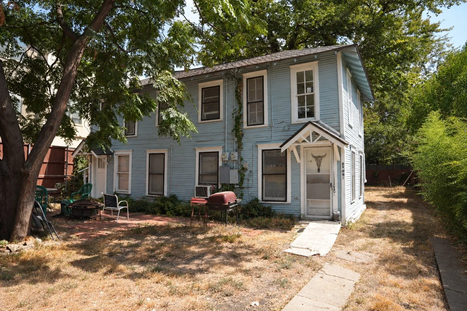Rear detached two-story duplex structure situated at the back half of the 200 ft lot.