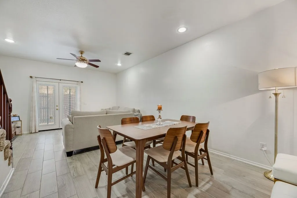 Recessed lighting, ceiling fan, wood-finish flooring, and French doors