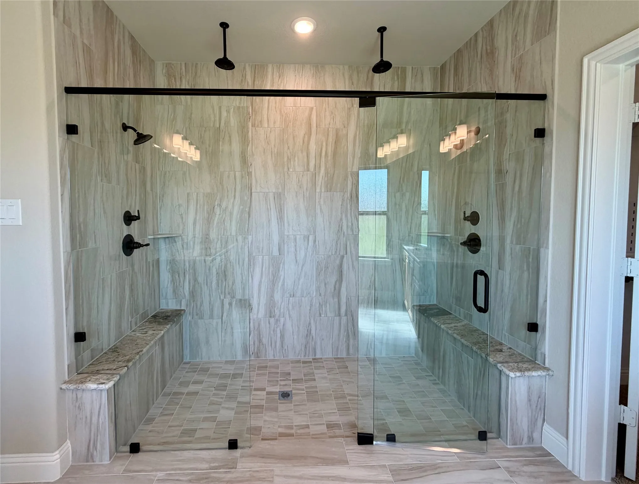 HUGE master shower with 2 granite benches, 2 shower heads & 2 rain heads!