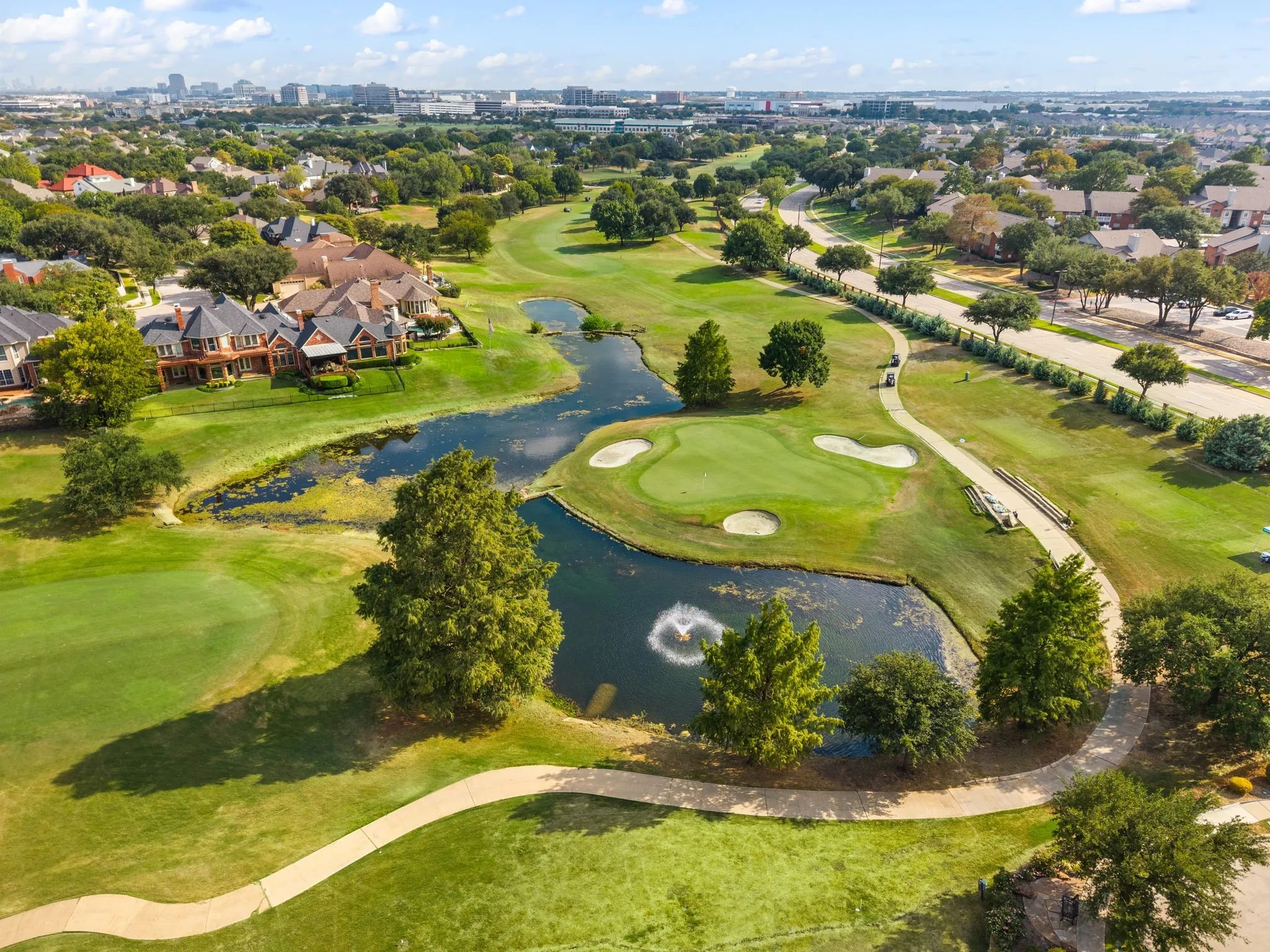 Manicured golf course setting with multiple greens and sand traps