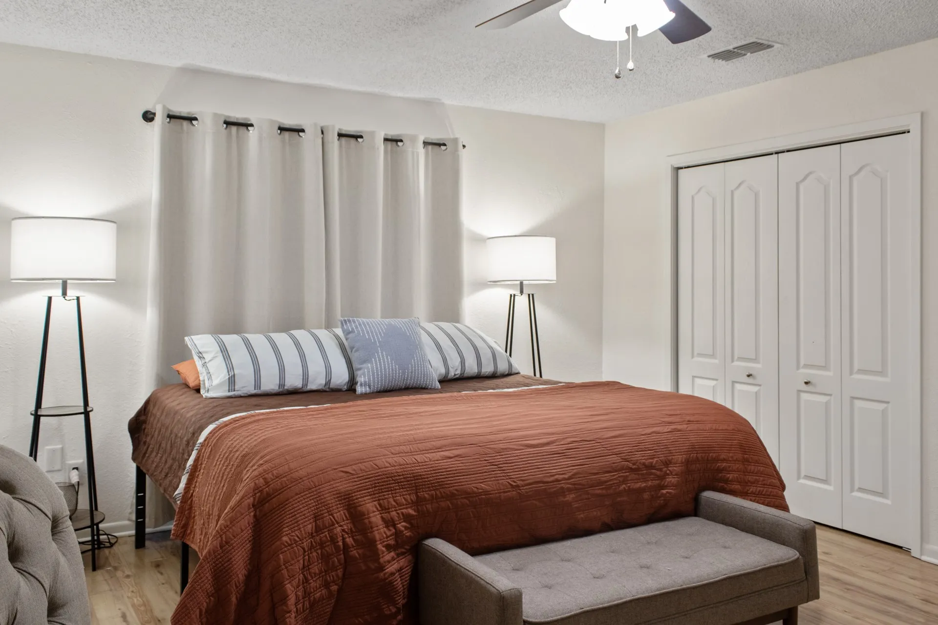Ceiling fan, wood-finish flooring, white walls, bi-fold closet doors, and recessed ceiling lighting