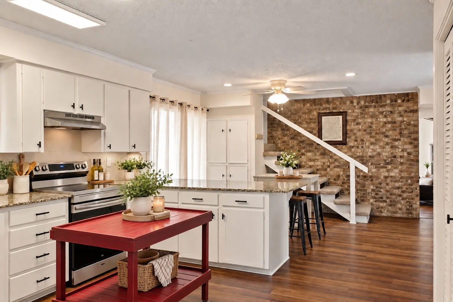 Kitchen featuring white cabinetry, stainless steel appliances, and stone countertops