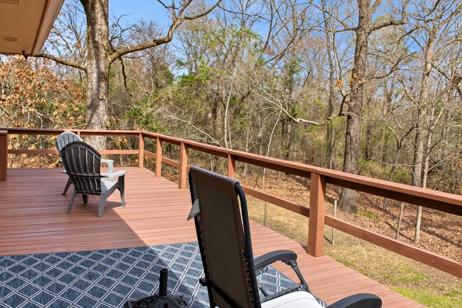 Expansive outdoor deck with a wood-tone surface and a perimeter railing