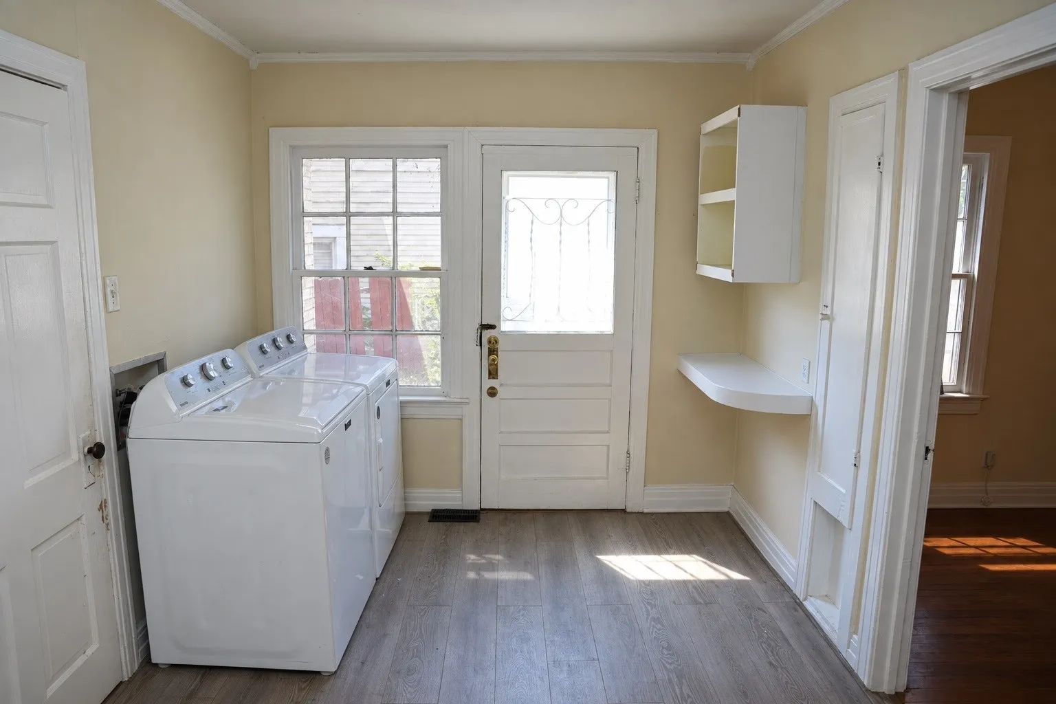 Dedicated laundry and utility room in front structure.