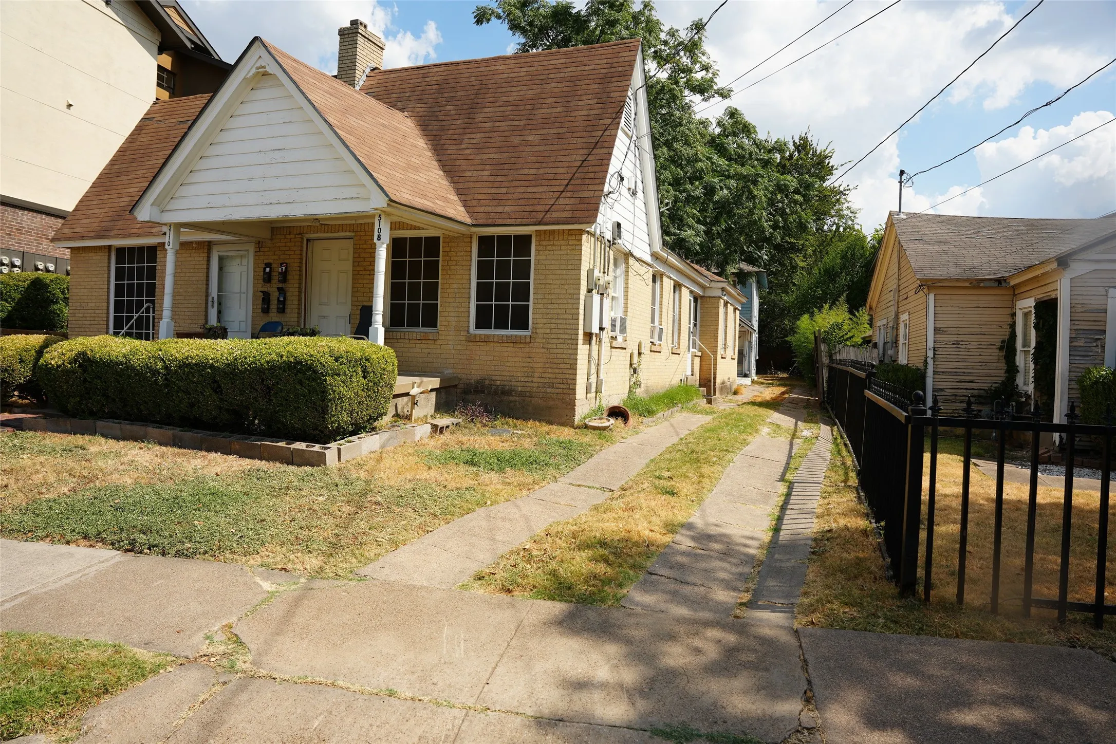 Front driveway and side approach along the west property boundary.