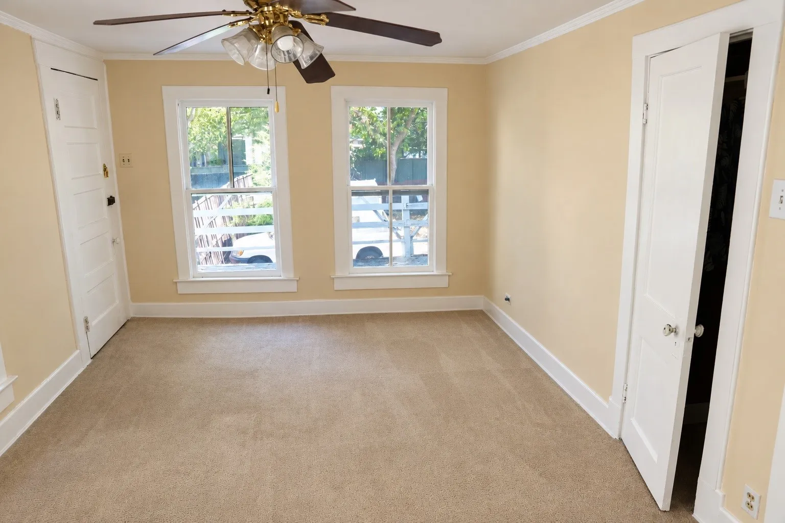 Rear duplex bedroom featuring natural light and clean flooring.