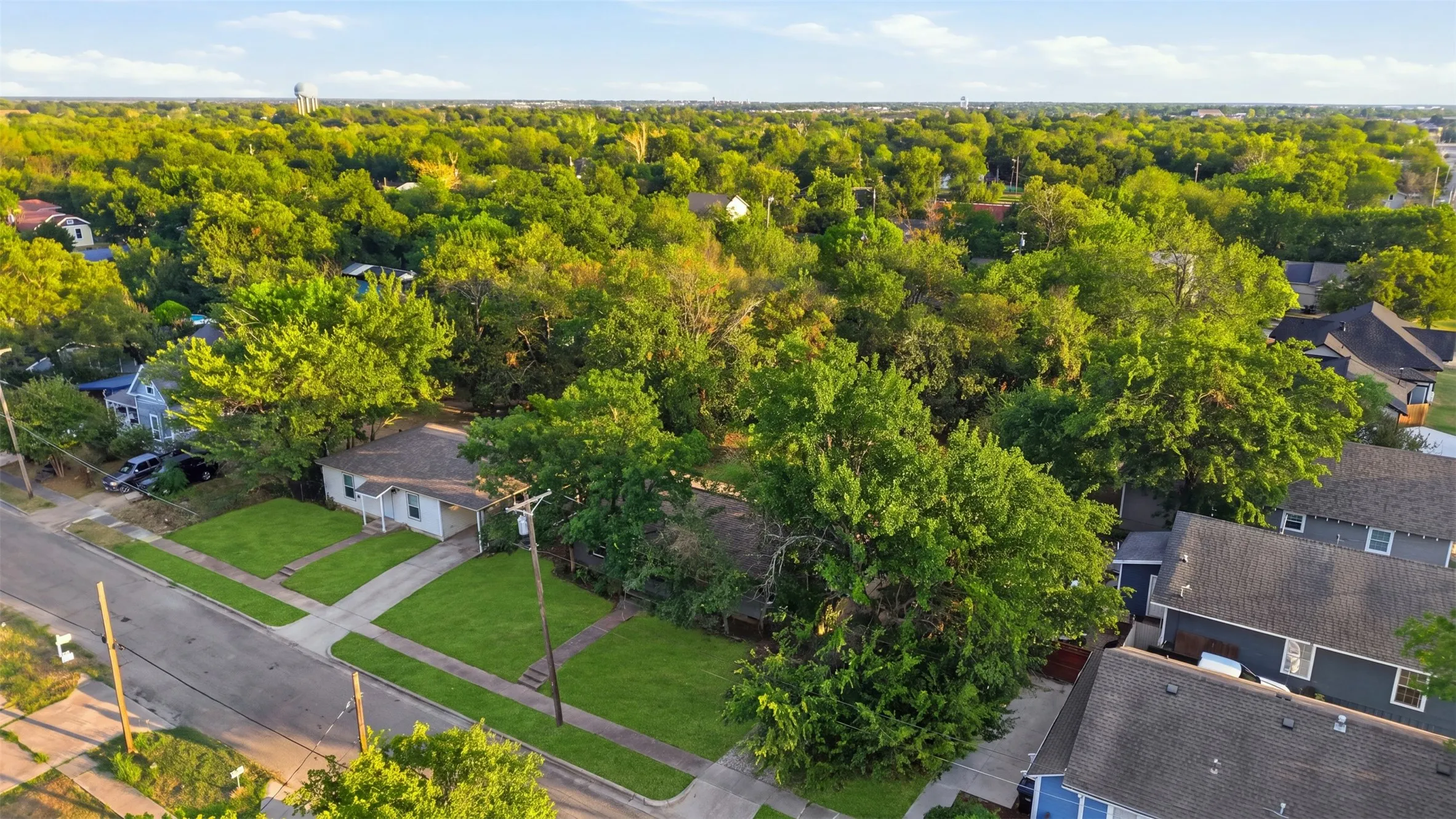 Aerial perspective of a residential neighborhood with mature trees