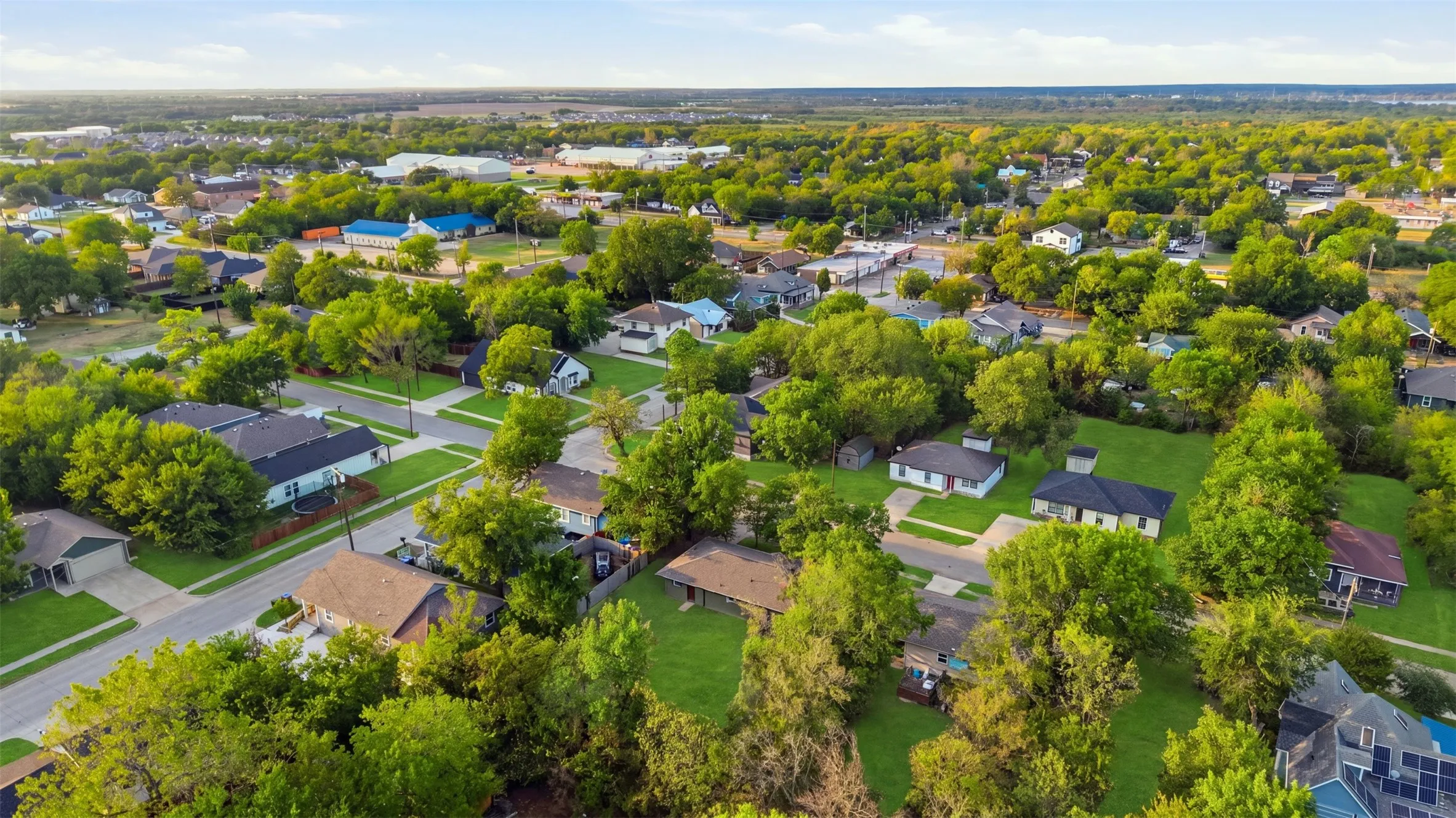 Residential neighborhood featuring established homes, mature trees, and paved streets