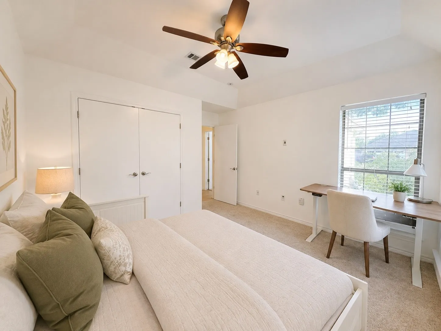 Vaulted ceiling with a ceiling fan, window with horizontal blinds, neutral carpeting, and white interior doors with brushed nickel hardware