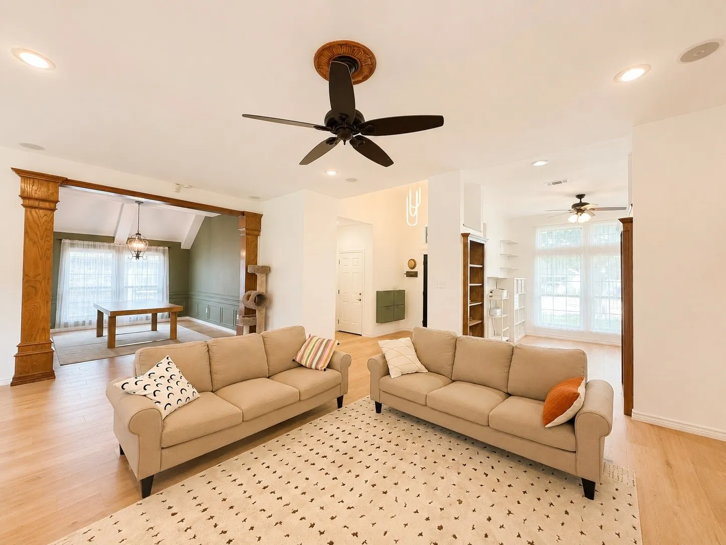 Recessed lighting, wood-finish flooring, and a ceiling fan with decorative medallion