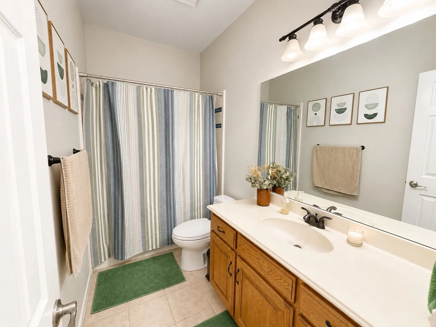 Bathroom featuring a single vanity with wood cabinetry, a white countertop, and a built-in sink