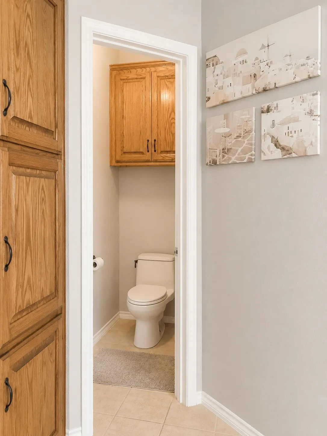 Built-in wood cabinetry, light neutral wall paint, and tile flooring