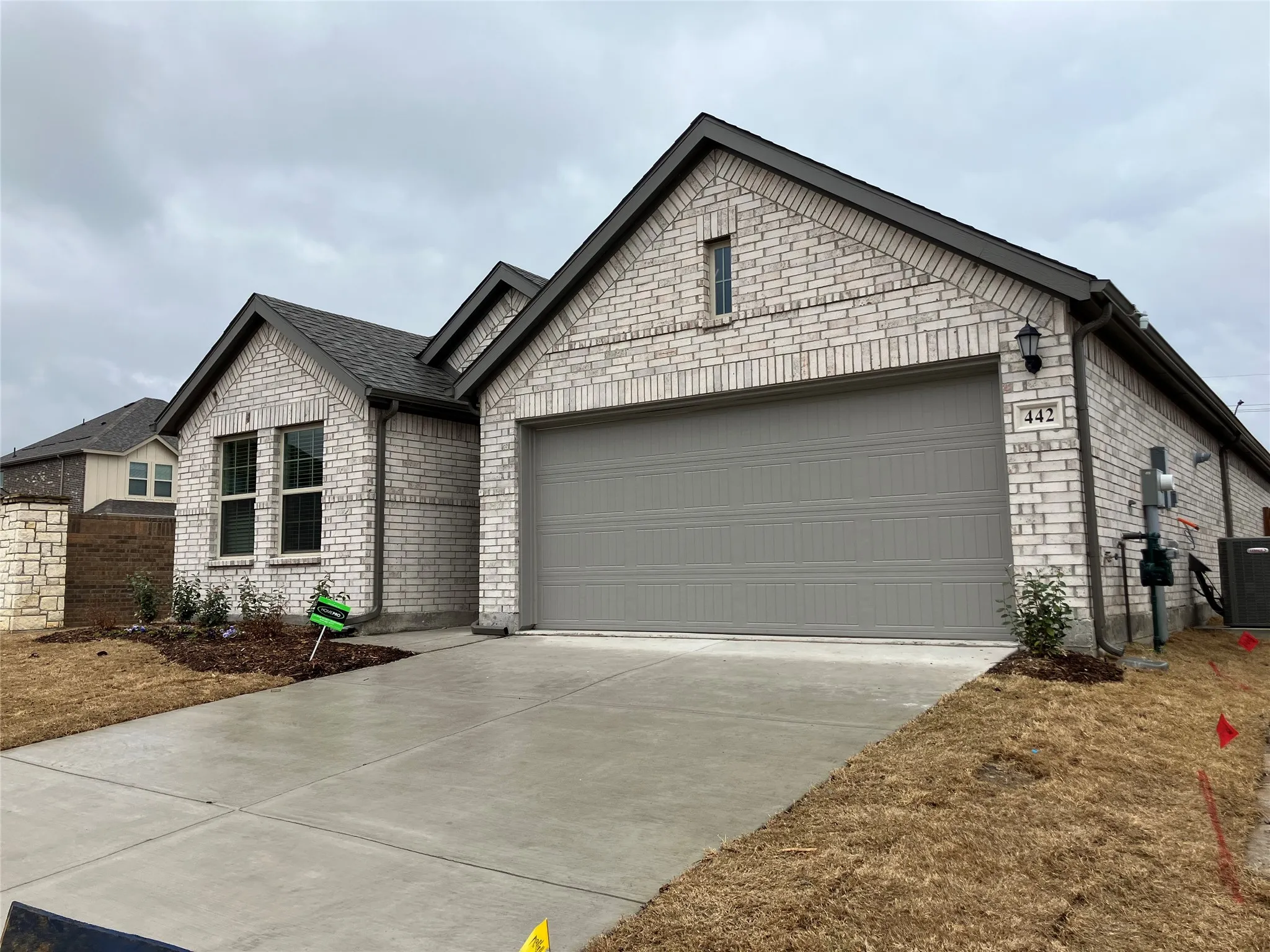 Brick exterior with dark gray trim and roof shingles