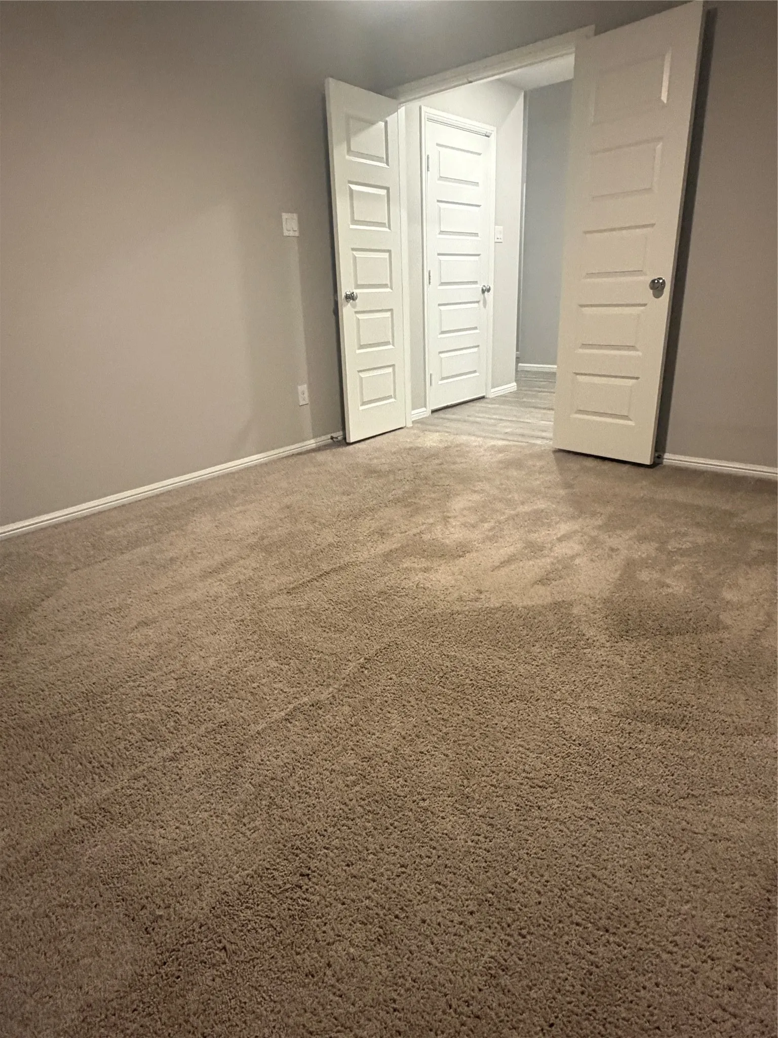 Light-toned walls complement plush carpeting
