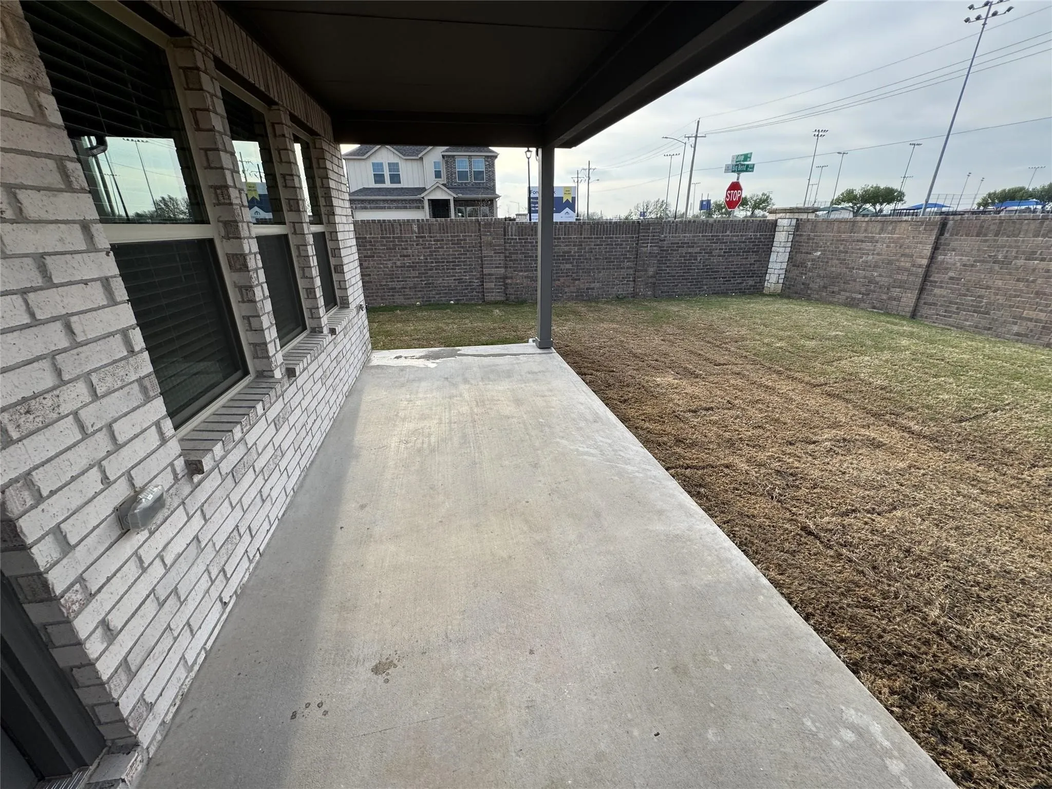 Concrete patio with an adjacent lawn area