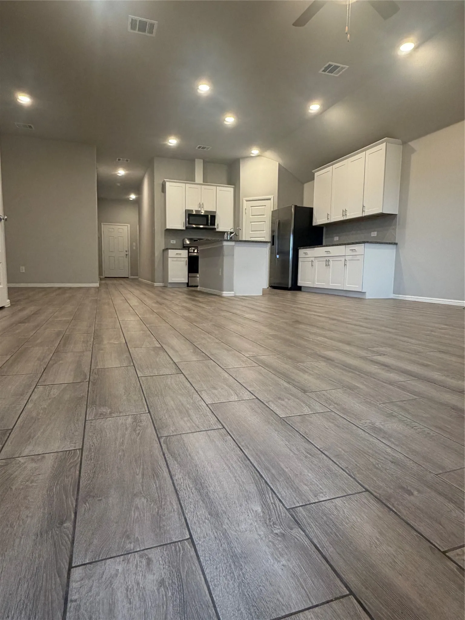 Light wood-finish flooring throughout, complemented by recessed lighting