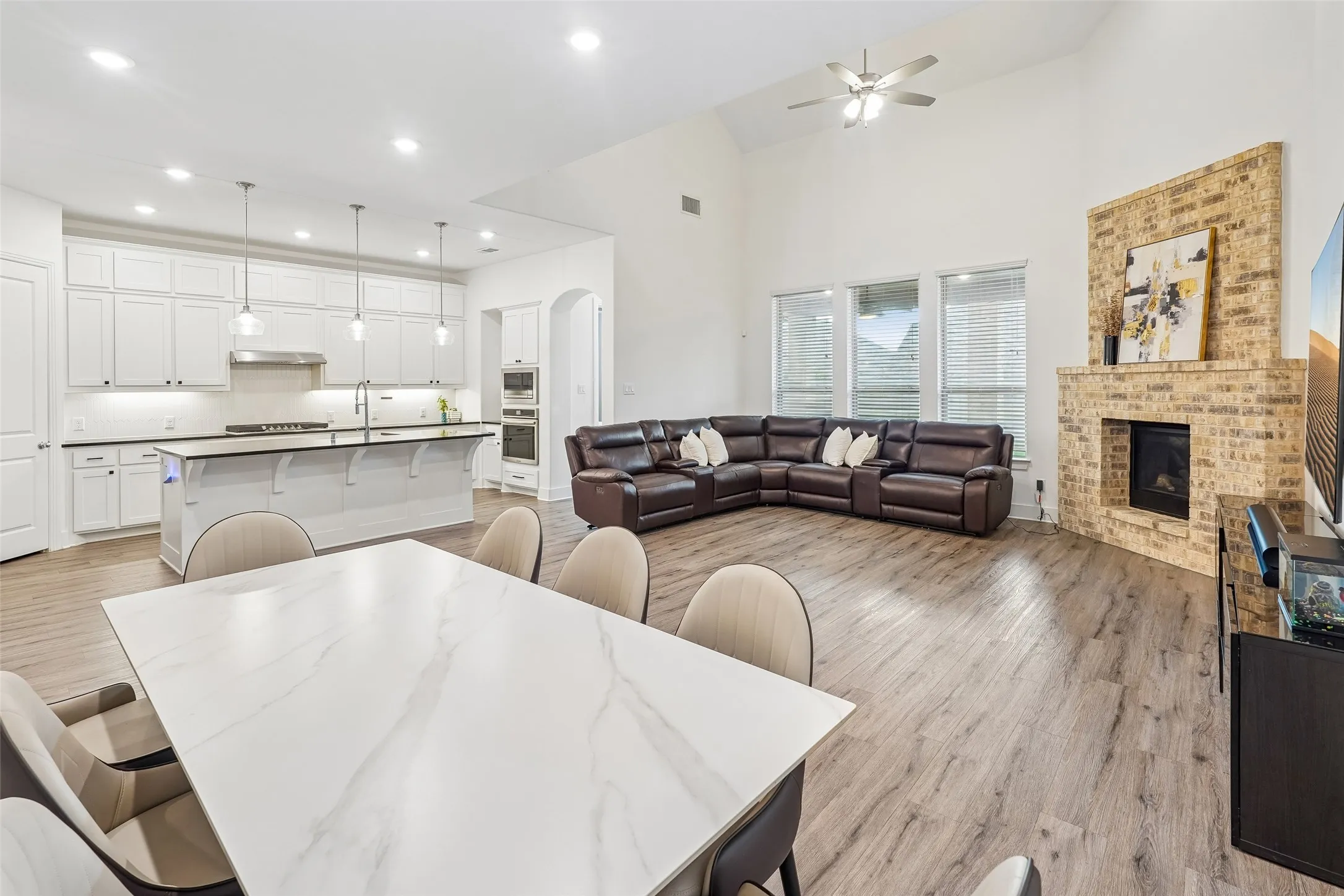Vaulted ceilings, wood-finish flooring, and a brick fireplace