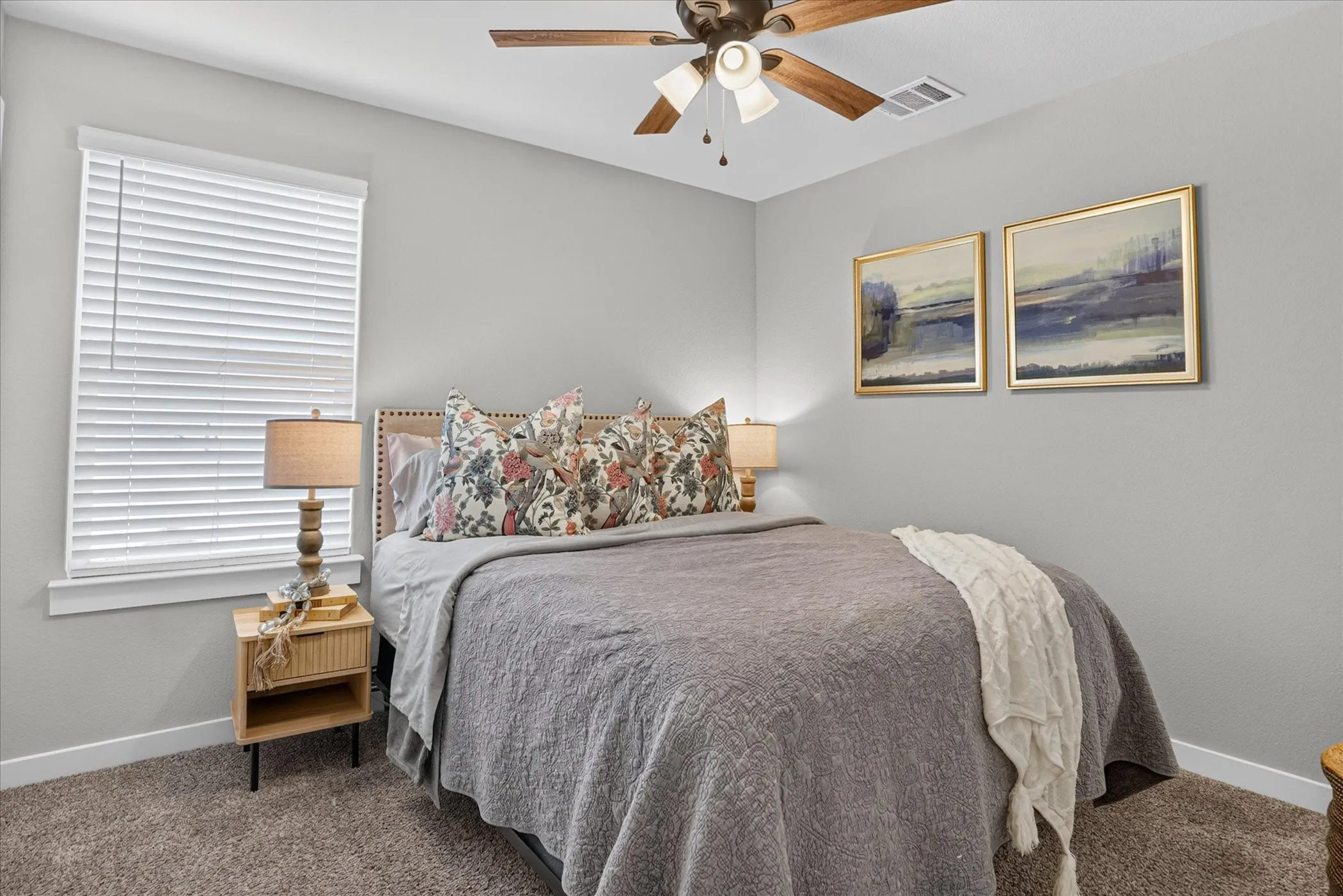 Carpeted flooring, blinds, and a built-in ceiling fan with integrated lighting