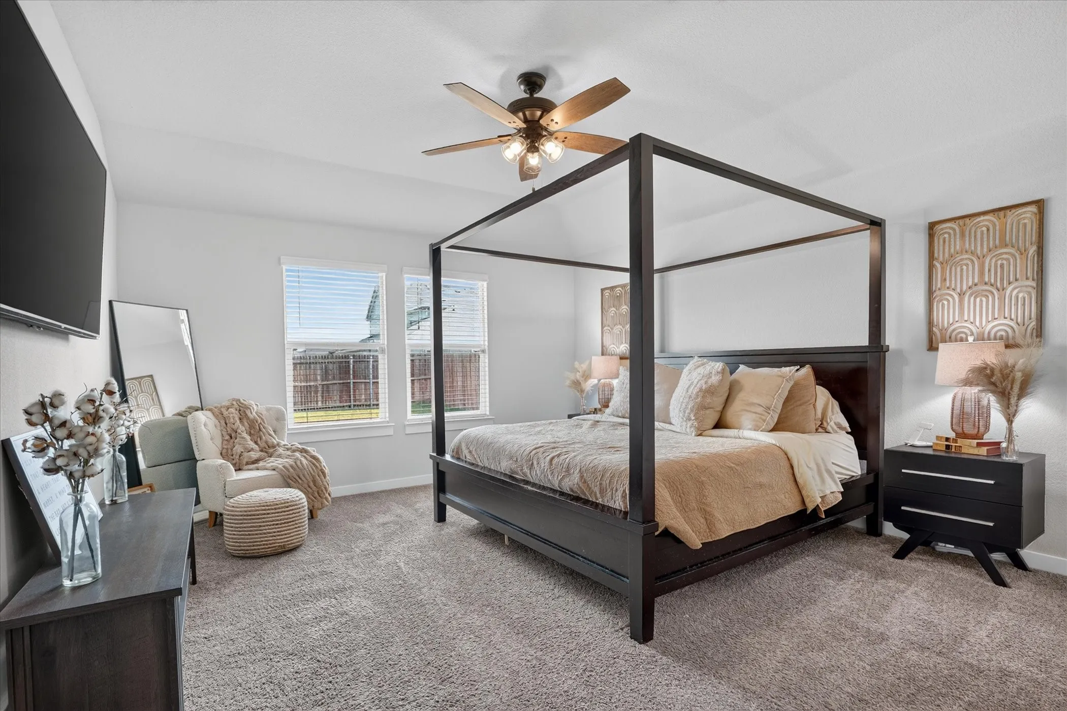Oversized primary bedroom, wood-finish ceiling fan, and carpeted flooring, wooden shutter blinds.