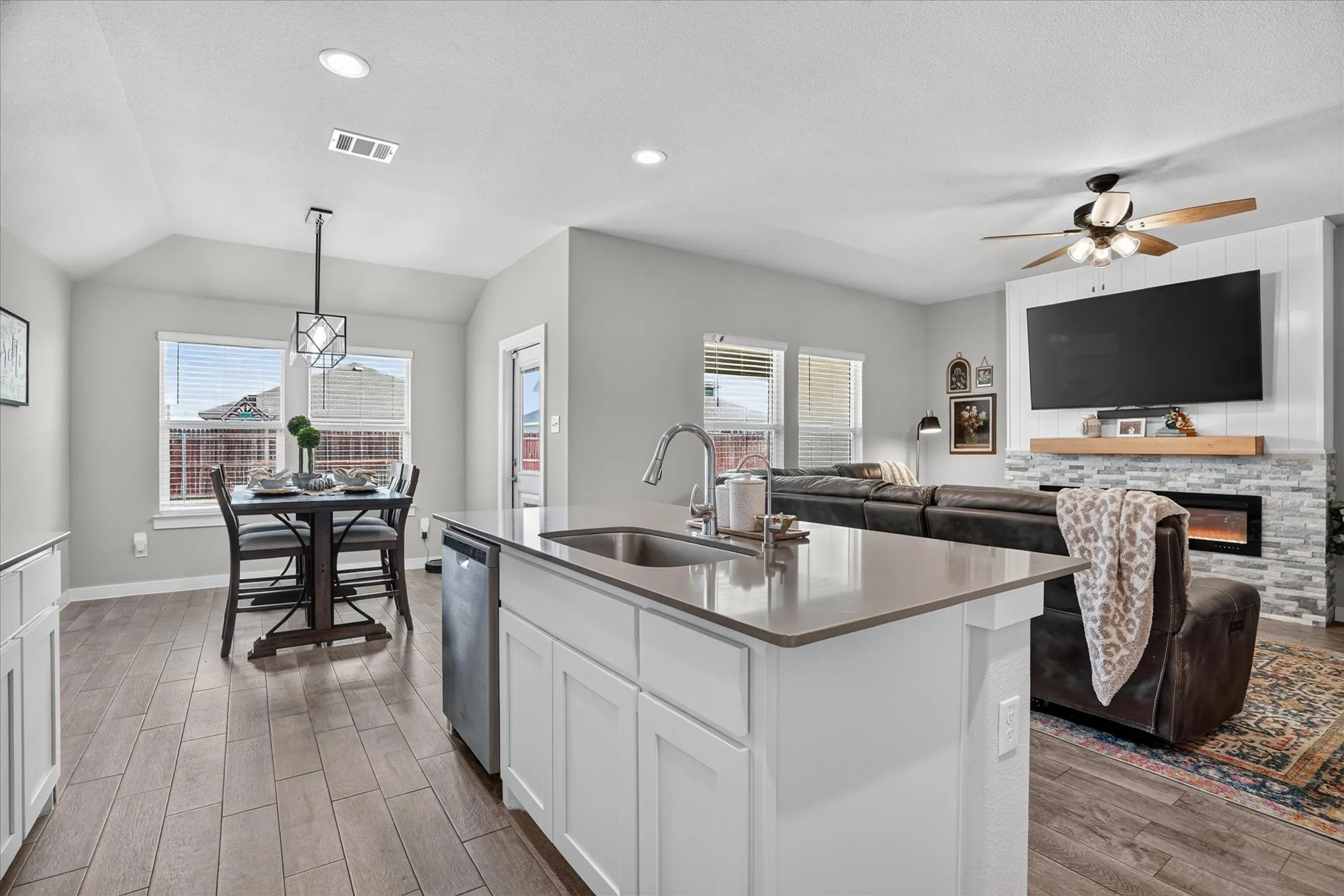 Open-concept living space with wood-finish flooring