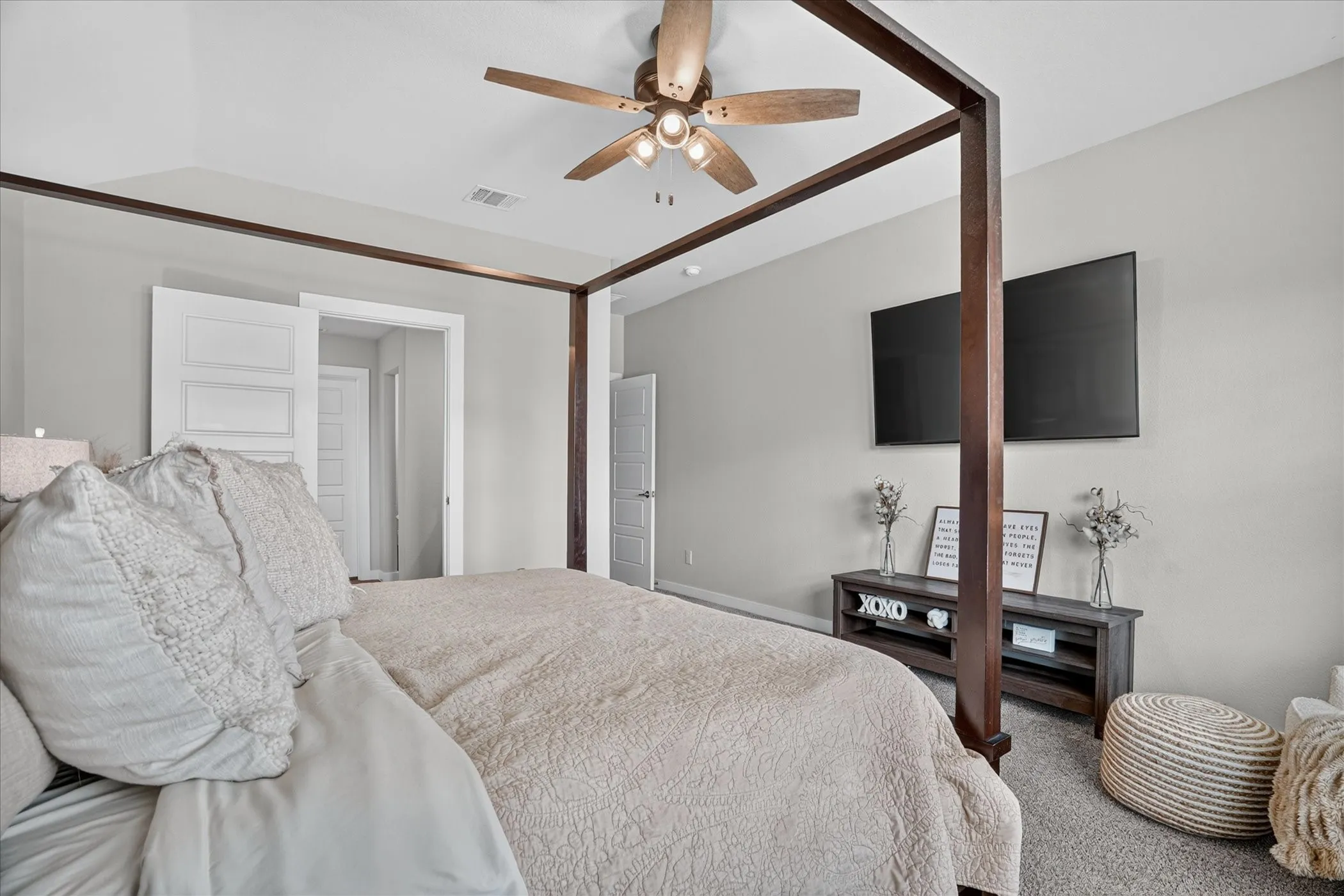 Wood-finish ceiling fan, recessed lighting, neutral wall paint, and gray carpet