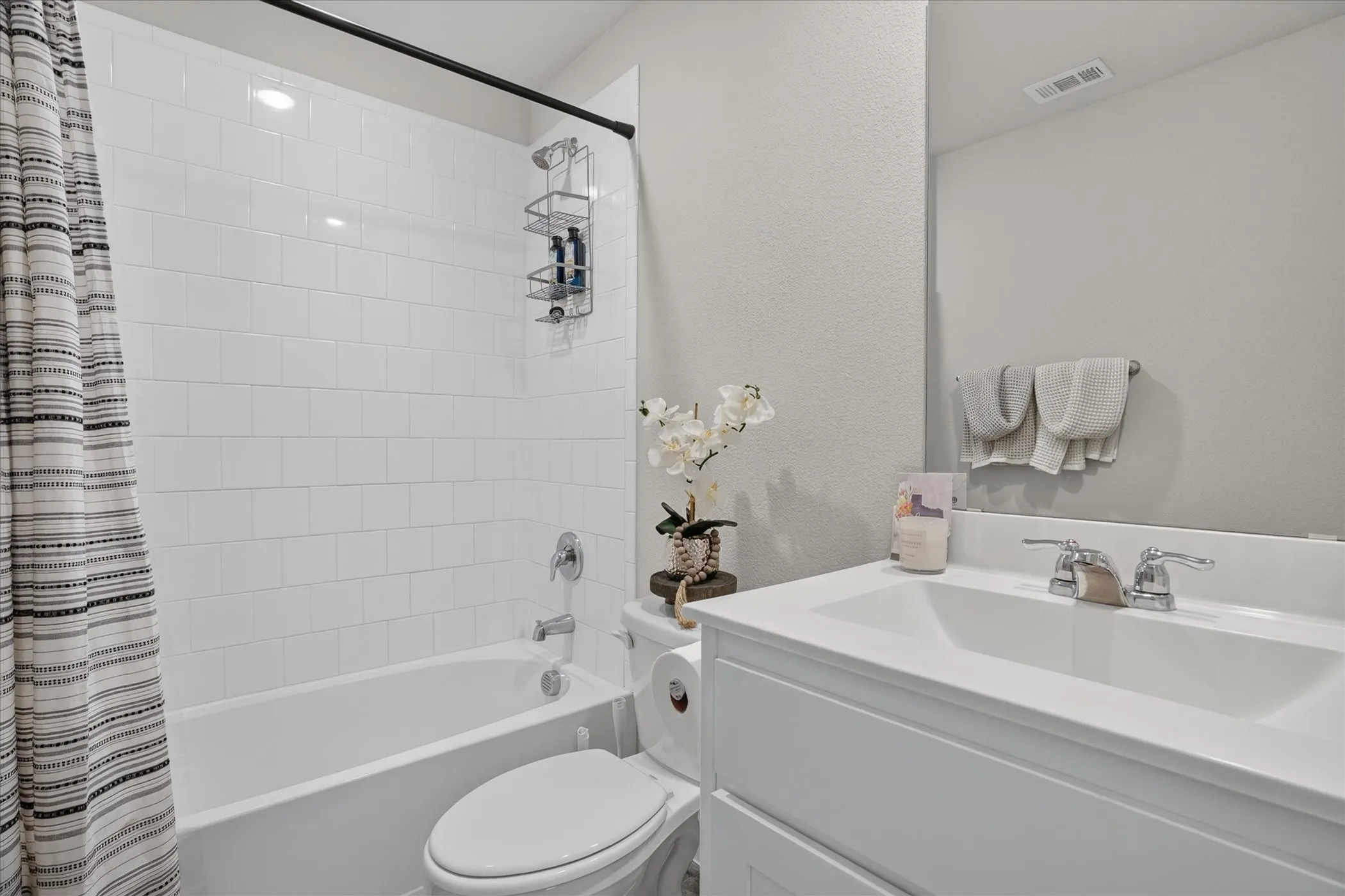 White subway tile shower surround with a built-in tub