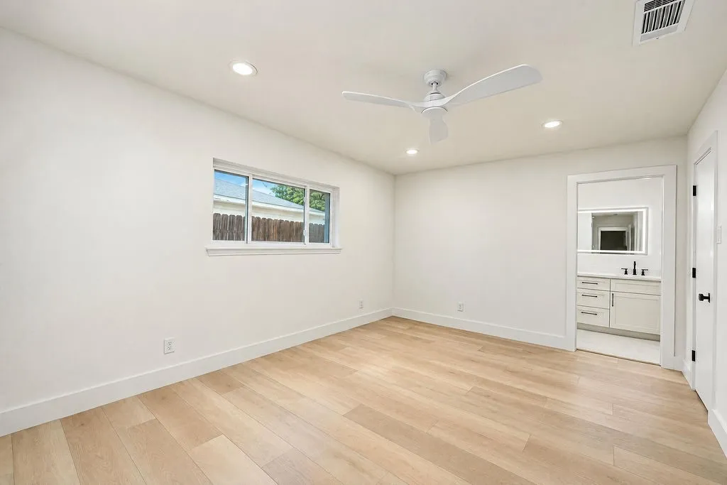 Recessed lighting, ceiling fan, wood-finish flooring, white walls, and a window