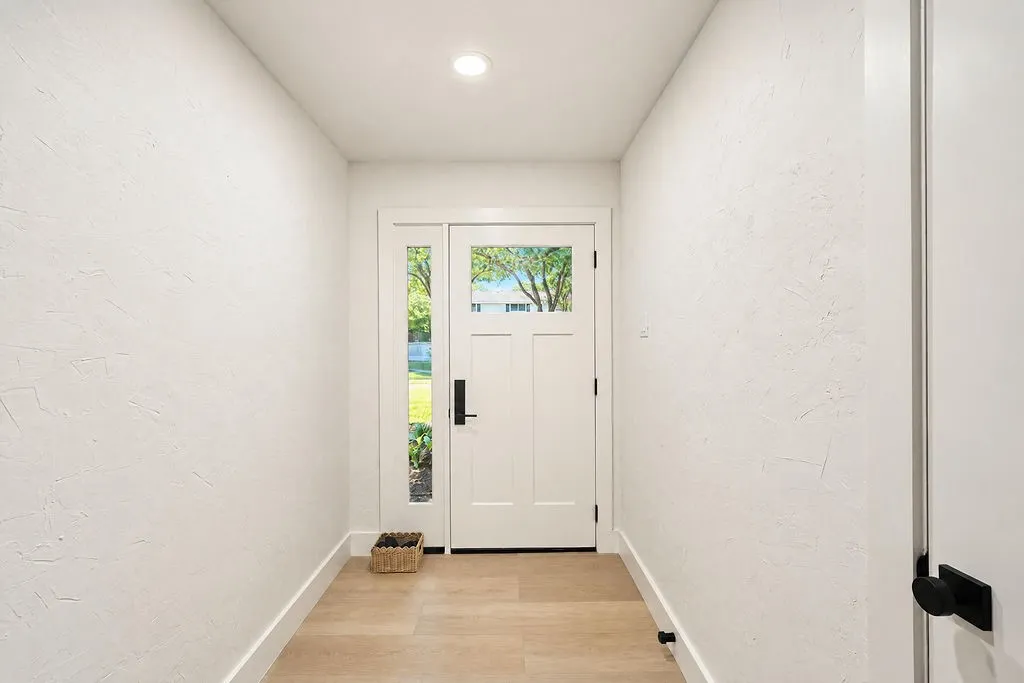 Entryway featuring a white paneled door with glass inserts, sidelite, wood-finish flooring, and recessed ceiling lighting