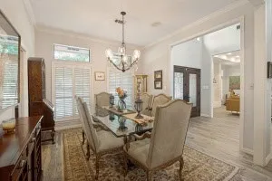 Recessed lighting, wood-finish flooring, and white plantation shutters
