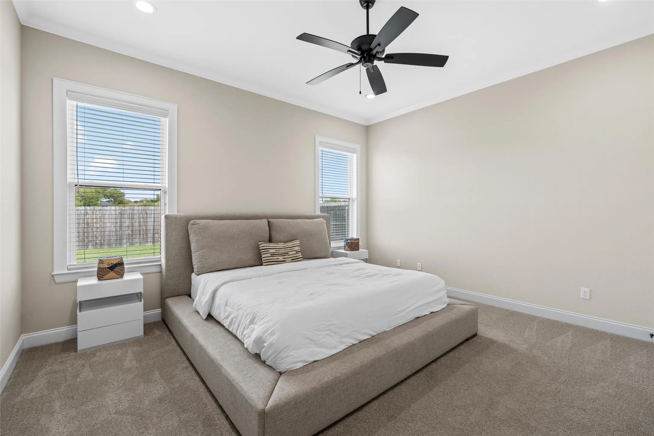 Recessed lighting, crown molding, and neutral wall paint
