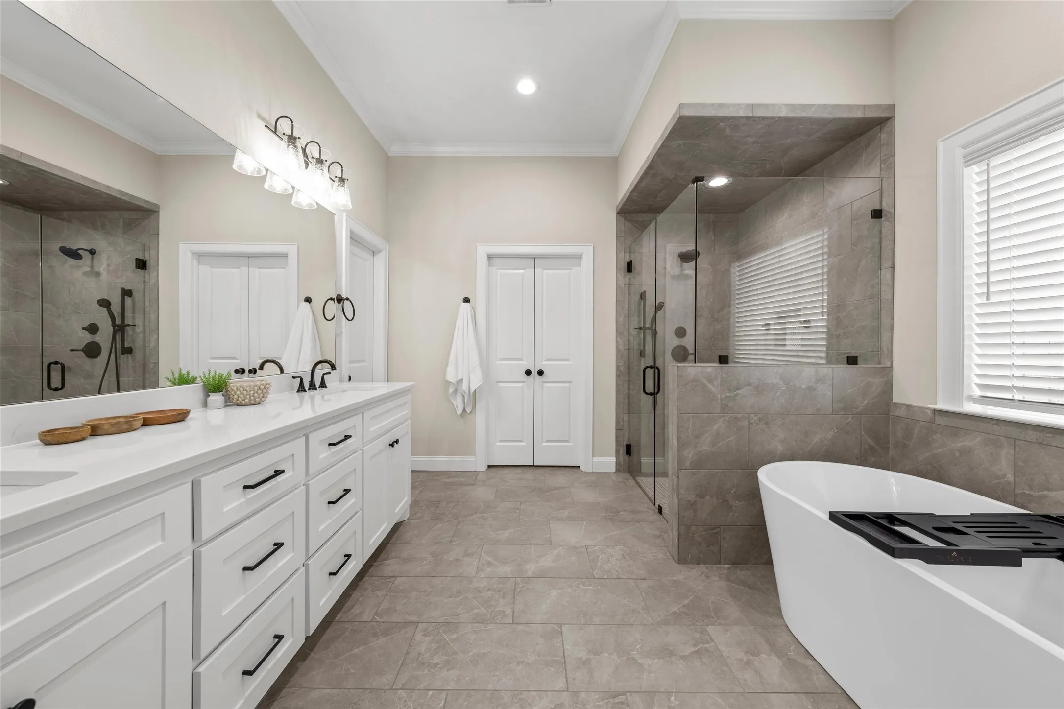 Dual vanity with white cabinetry and black hardware