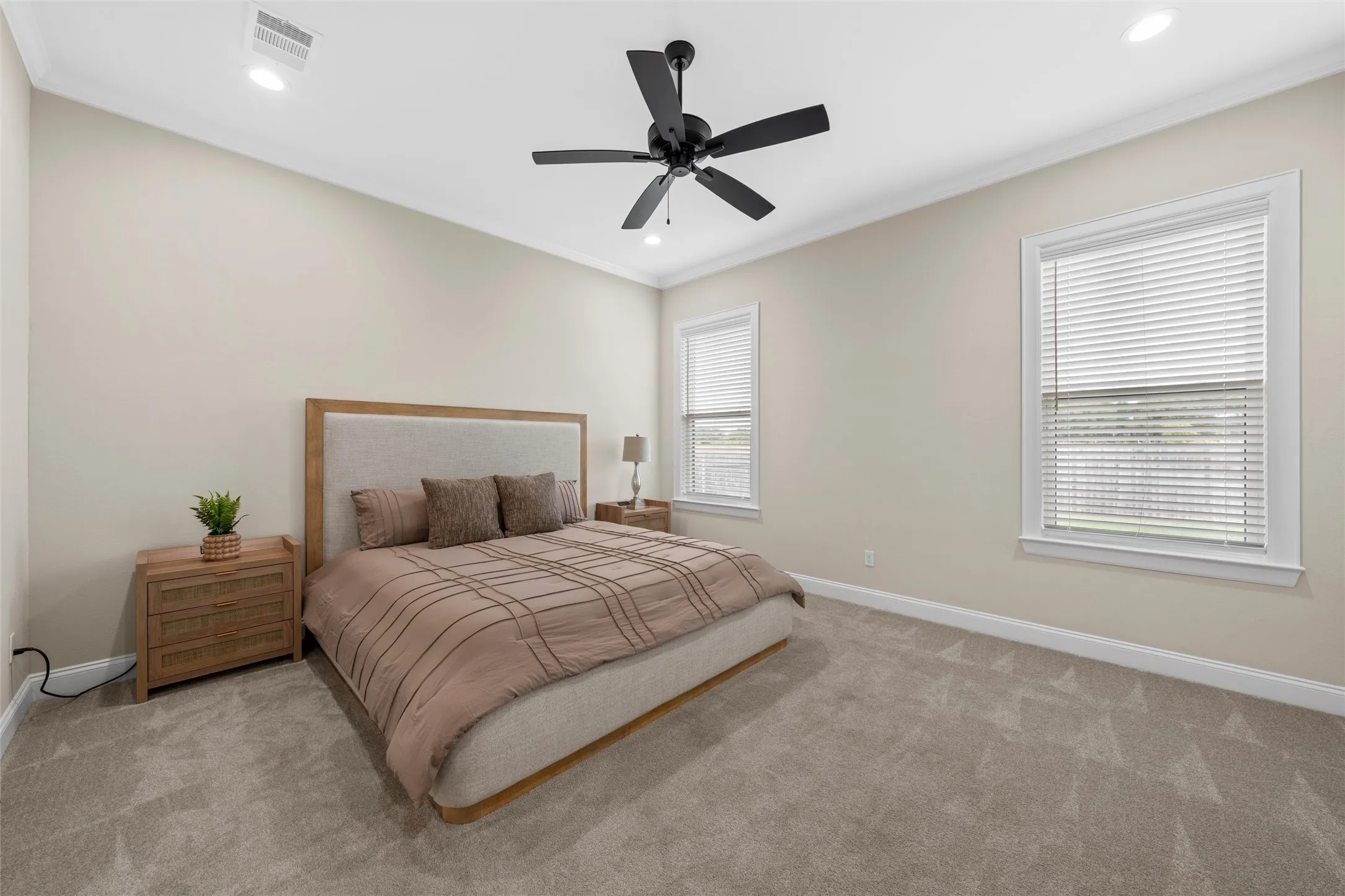Recessed lighting, crown molding, and two windows with blinds